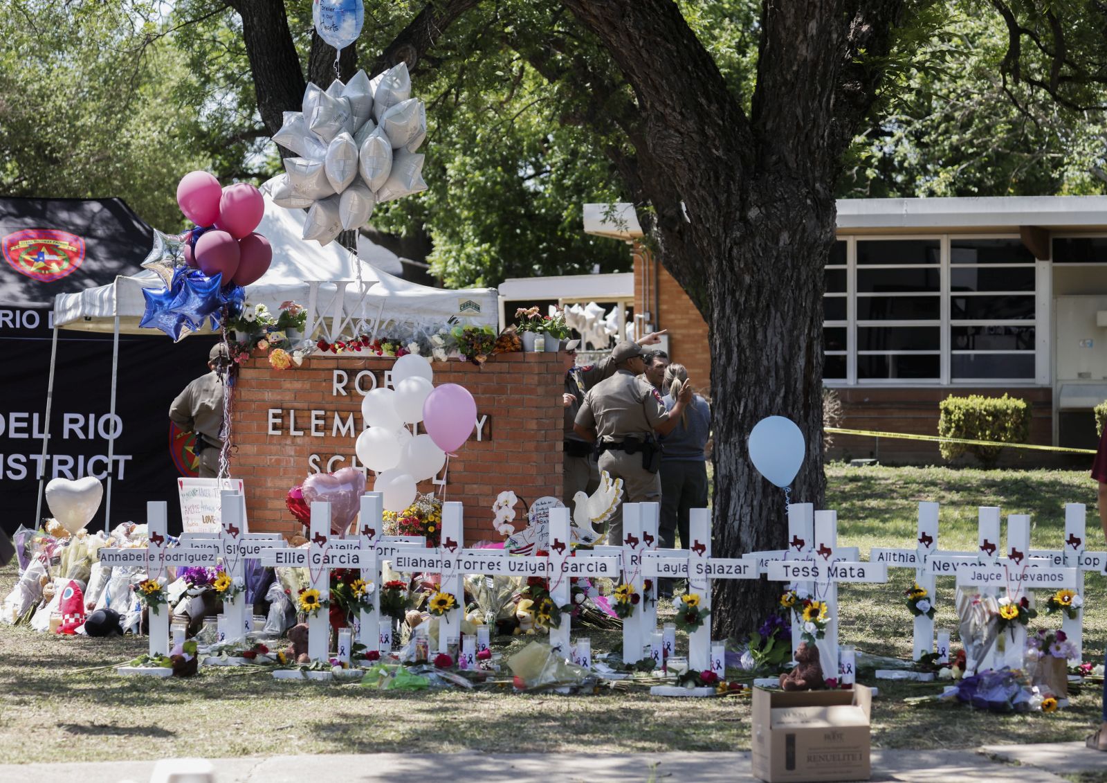 epa09978423 Crosses bearing names of victims line an area on school ground following a mass shooting at the Robb Elementary School in Uvalde, Texas, USA, 26 May 2022. According to Texas officials, at least 19 children and two adults were killed in the shooting on 24 May. The eighteen-year-old gunman was killed by responding officers.  EPA/TANNEN MAURY
