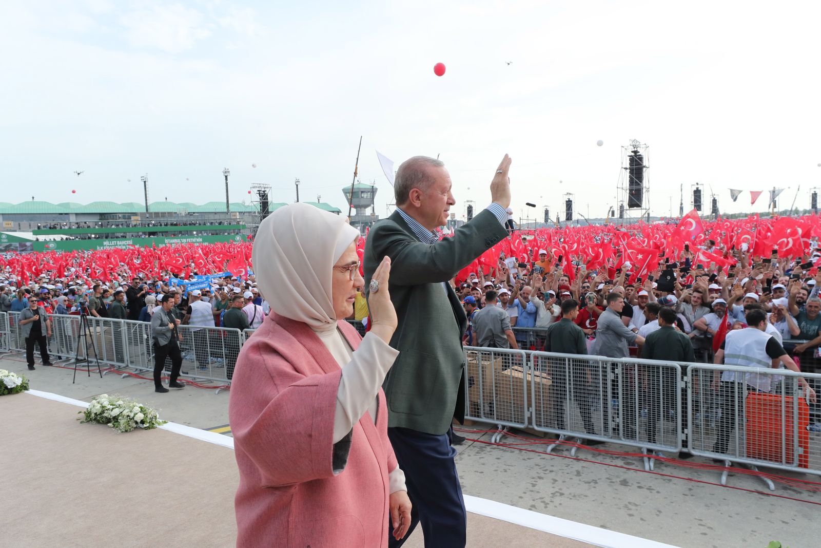 epa09984638 A handout photo made available by the Turkish President's Press Office shows Turkish President Recep Tayyip Erdogan (back) and his wife Emine Erdogan (front) greet their supporters during a ceremony of the transformation of the Ataturk Airport into a national garden in Istanbul, Turkey, 29 May 2022. A total of 132,500 saplings will be planted in an area that will be the biggest park in Turkey.  EPA/TURKISH PRESIDENT PRESS OFFICE HANDOUT  HANDOUT EDITORIAL USE ONLY/NO SALES