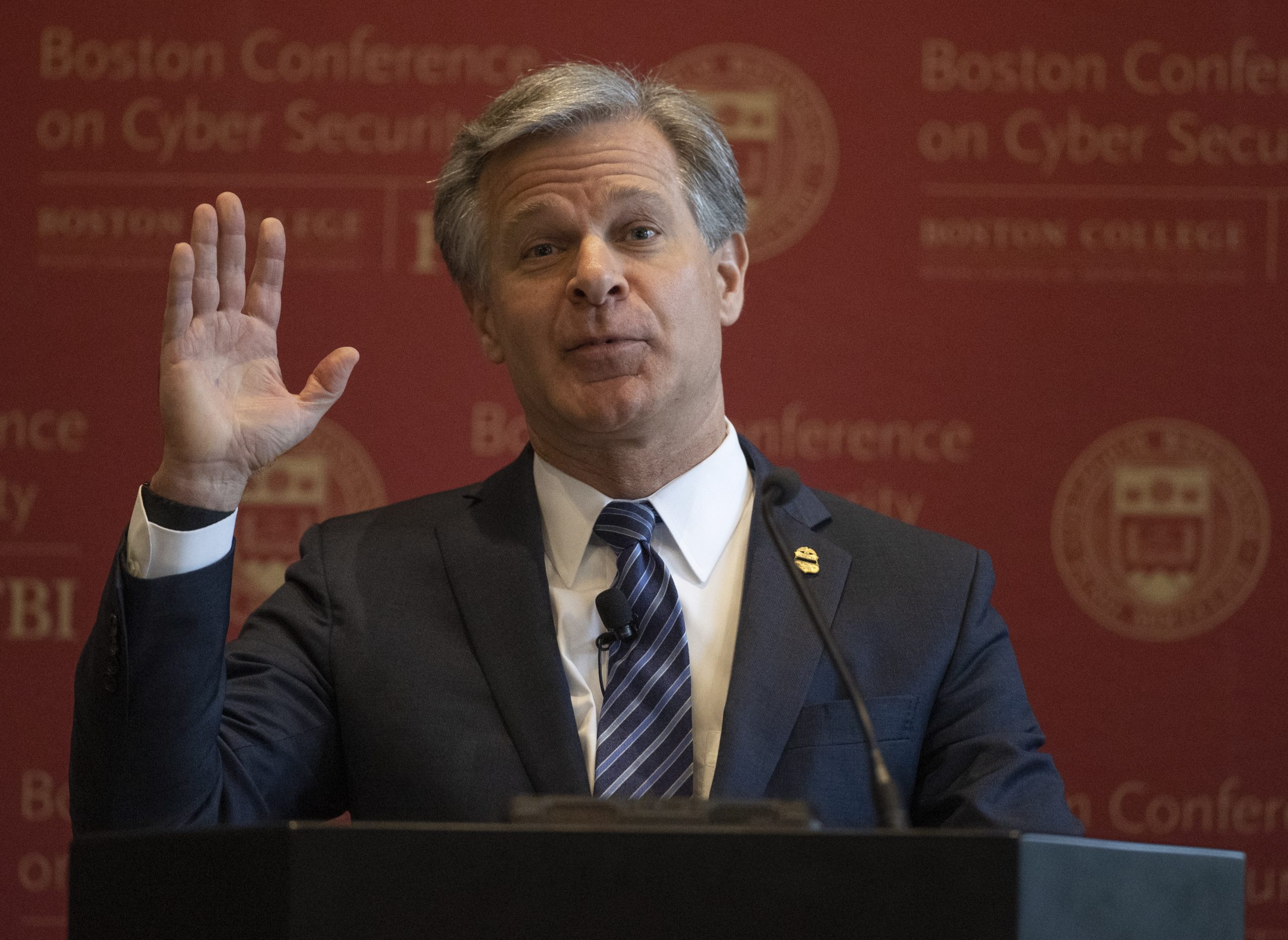 epa09989850 FBI Director Christopher A. Wray gesture during his keynote address at the sixth annual Boston Conference on Cyber Security at Boston College, in Boston, Massachusetts, USA, 01 June 2022.  EPA/CJ GUNTHER