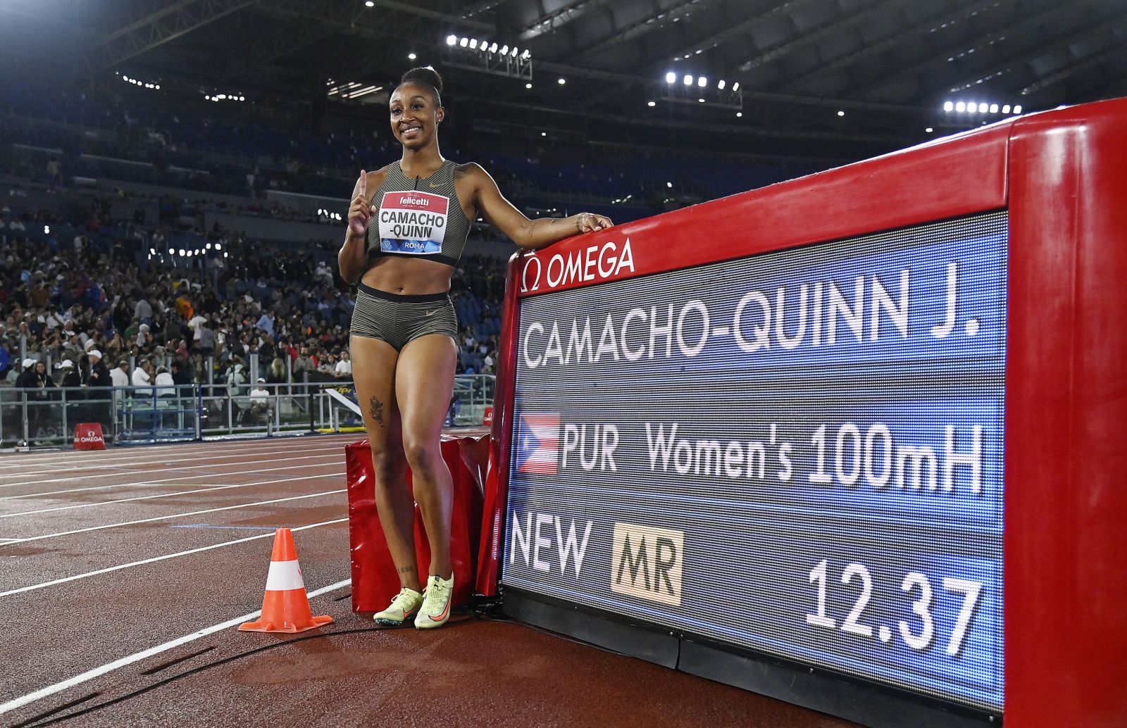 epa10004849 Jasmine Camacho-Quinn of Puerto Rico poses after setting a new meeting record time of 12.37 seconds in the women's 100m Hurdles race of the Diamond League Golden Gala athletics meeting at the Olimpico stadium in Rome, Italy, 09 June 2022.  EPA/Riccardo Antimiani