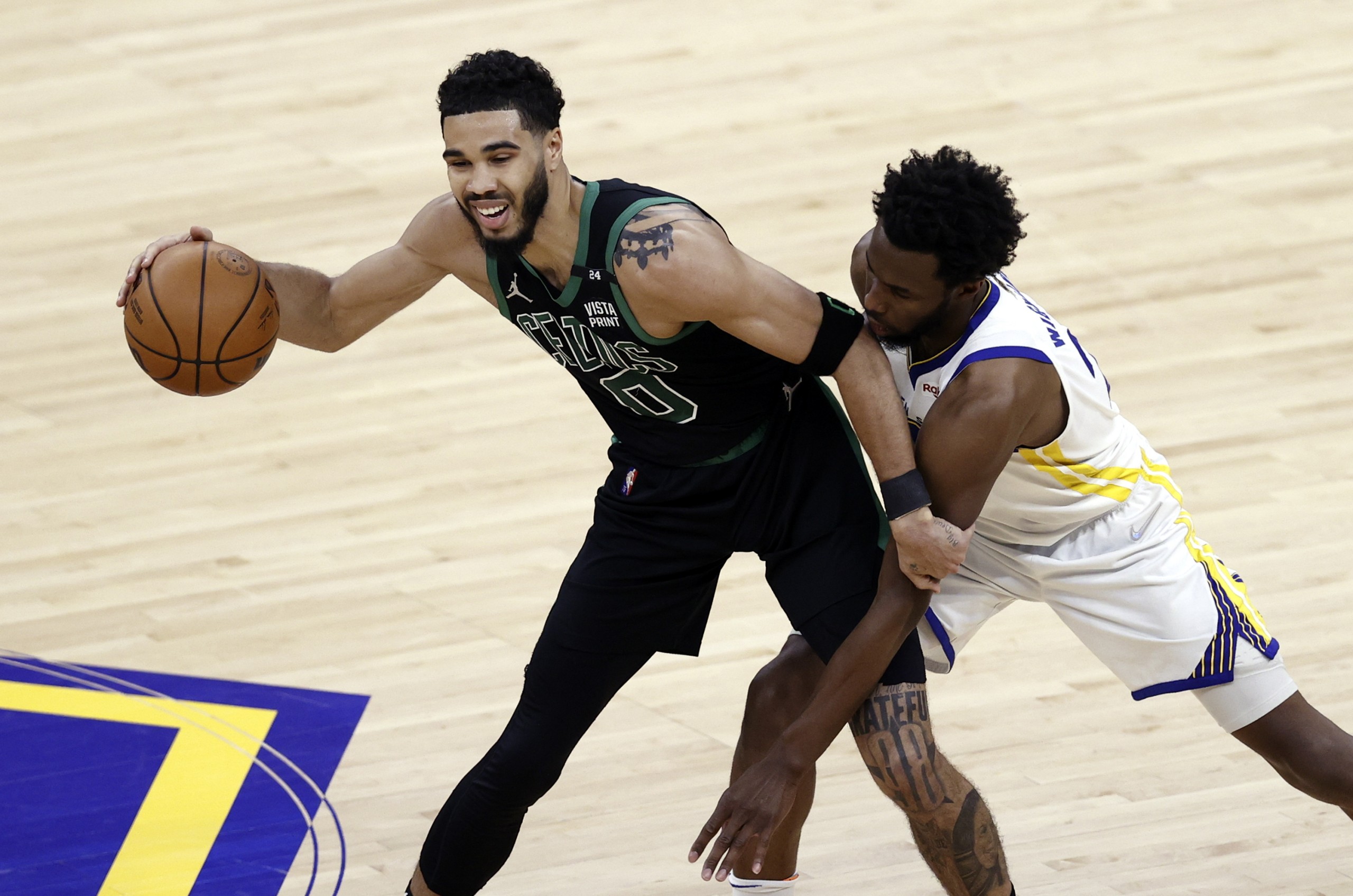 epa10011825 Boston Celtics forward Jayson Tatum (L) looks to control a loose ball while being defended by Golden State Warriors forward Andrew Wiggins (R) during the first half of the National Basketball Association (NBA) Finals playoff game five between the Golden State Warriors and the Boston Celtics at the Chase Center in San Francisco, California, USA, 13 June 2022.  EPA/JOHN G. MABANGLO SHUTTERSTOCK OUT