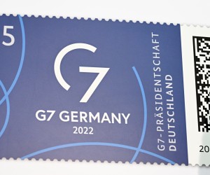 epa10014170 The G7 Presidency special postage stamp is displayed during its presentation, in Berlin, Germany, 15 June 2022.  EPA/FILIP SINGER