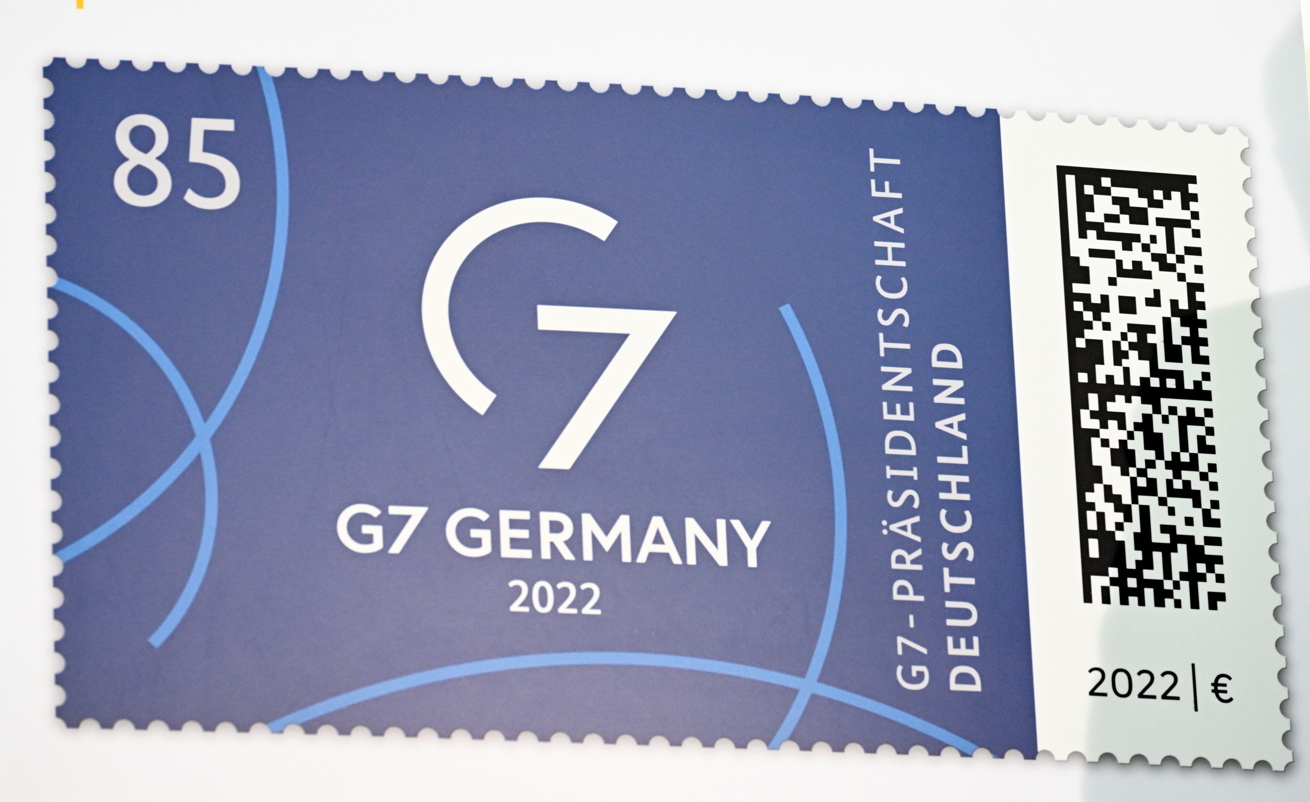 epa10014170 The G7 Presidency special postage stamp is displayed during its presentation, in Berlin, Germany, 15 June 2022.  EPA/FILIP SINGER