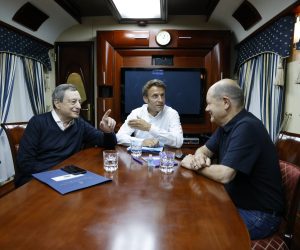 epa10015399 (L-R) Italian Prime Minister Mario Draghi, French President Emmanuel Macron and German Chancellor Olaf Scholz talk inside a train carriage at an undisclosed location on their way from Poland to Kyiv, Ukraine, 16 June 2022. The three EU leaders will meet Ukrainian President Volodymyr Zelensky.  EPA/LUDOVIC MARIN / POOL MAXPPP OUT