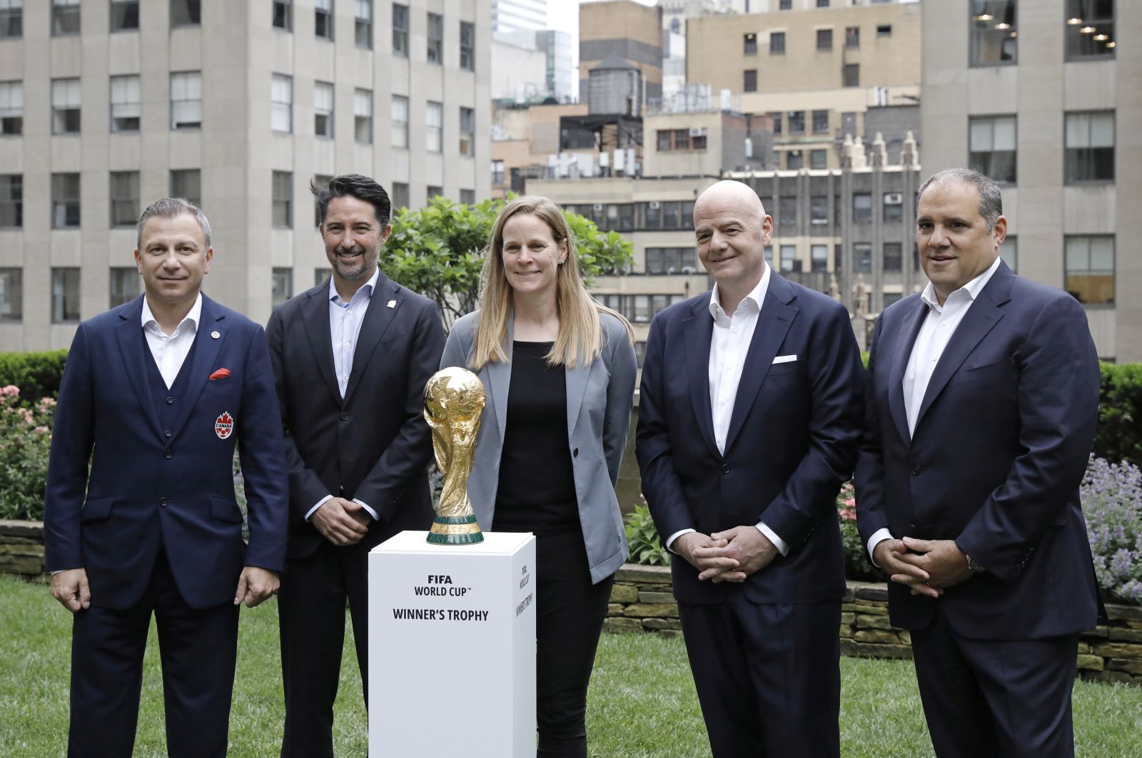 epa10017324 (L-R) Nick Bontis, President of Canada Soccer, Yon de Luisa Plazas, President of the Mexican Football Federation, US Soccer President Cindy Parlow Cone, FIFA President Gianni Infantino, and Vice President Vittorio Montagliani, pose for photographers with the FIFA World Cup trophy at Radio City in New York, New York, USA, 16 June 2022.The North American cities hosting the 2026 World Cup were announced, eleven sites are in the US, three are in Mexico, and two in Canada.  EPA/Peter Foley