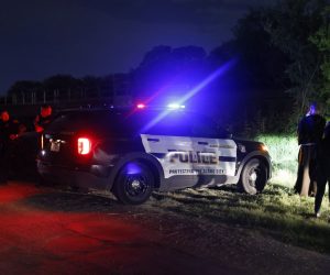 epa10037771 Police and officials man a roadblock near a tractor trailor on the side of the road leading to the location where more at least 46 migrants were reportedly found dead along with at least 15 who were still alive, on a roadway near railroad tracks in San Antonio, Texas, USA, 28 June 2022.  EPA/ADAM DAVIS