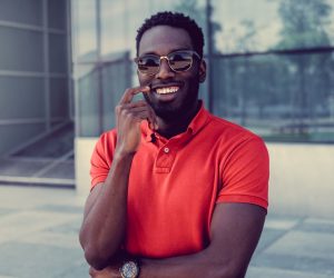 Portrait of smiling african american male in a red polo t shirt.