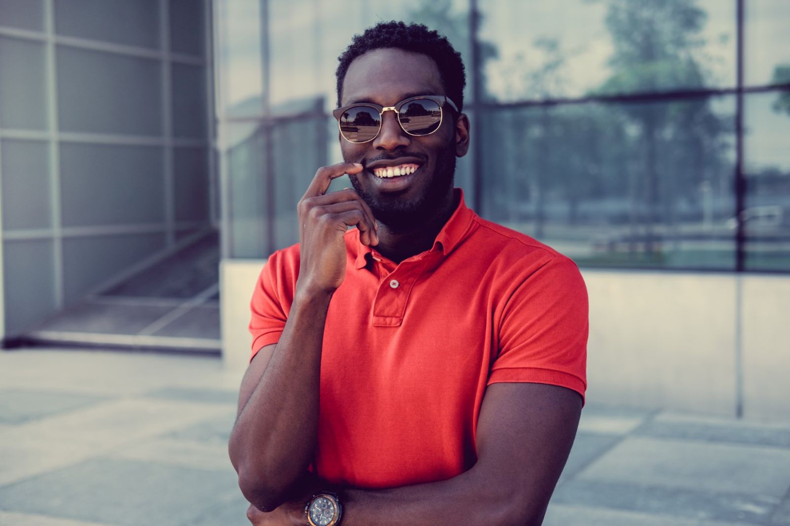 Portrait of smiling african american male in a red polo t shirt.