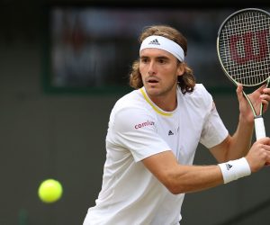 epa10048235 Stefanos Tsitsipas of Greece in action against Nick Kyrgios of Australia during their Men's third round match at the Wimbledon Championships, in Wimbledon, Britain, 02 July 2022.  EPA/KIERAN GALVIN   EDITORIAL USE ONLY