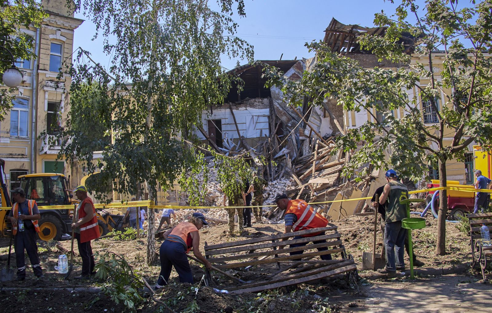 epa10055479 Ukrainian rescuers clean debris of a military registration and enlistment office following a Russian rocket strike hitting the building in the city of Kharkiv, Ukraine, 06 July 2022. Kharkiv and surrounding areas are currently being targeted by Russian forces with shelling and airstrikes.  EPA/SERGEY KOZLOV
