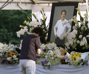 epa10064819 A woman mourner pays floral tribute for former Prime Minister Shinzo Abe at Zojoji Temple, where a private family wake for former is held in Tokyo, Japan, 11 July 2022.  Abe was shot dead on 08 July by a 41-year-old former member of the Japan Maritime Self-Defense Force, in Nara, western Japan, during an Upper House election campaign to support a candidate of his ruling party.  EPA/KIMIMASA MAYAMA