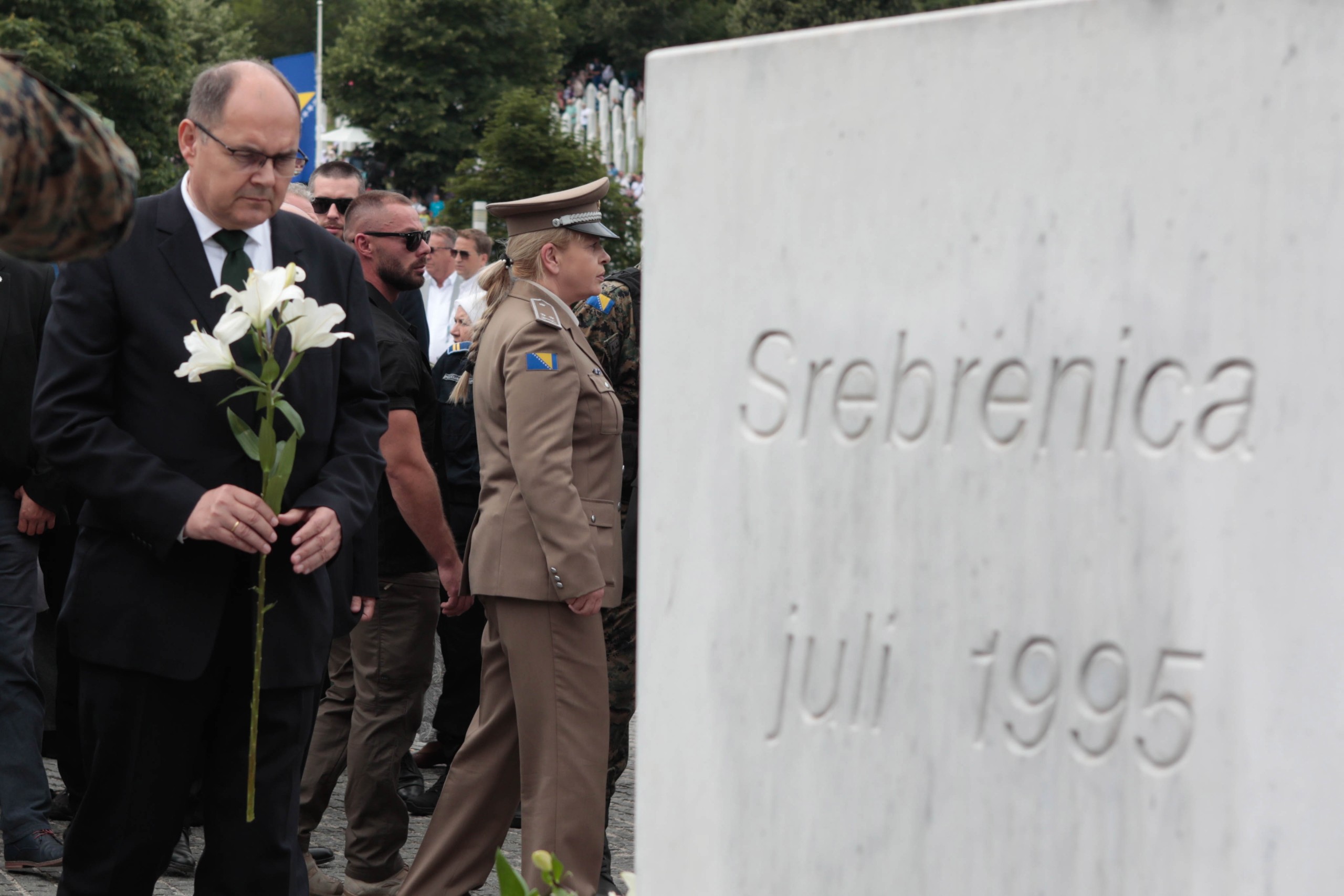 epa10065057 The High Representative and EU Special Representative in Bosnia and Herzegovina, German diplomat Christian Schmidt lays flowers at Potocari Memorial Center during a funeral ceremony for fifty newly-identified Bosnian Muslim victims, at the Potocari Memorial Center and Cemetery in Srebrenica, Bosnia and Herzegovina, 11 July 2022. The burial was part of a memorial ceremony to mark the 27th anniversary of the Srebrenica genocide, considered the worst atrocity of Bosnia's 1992-95 war. More than 8,000 Muslim men and boys were executed in the 1995 killing spree after Bosnian Serb forces overran the town.  EPA/JASMIN BRUTUS