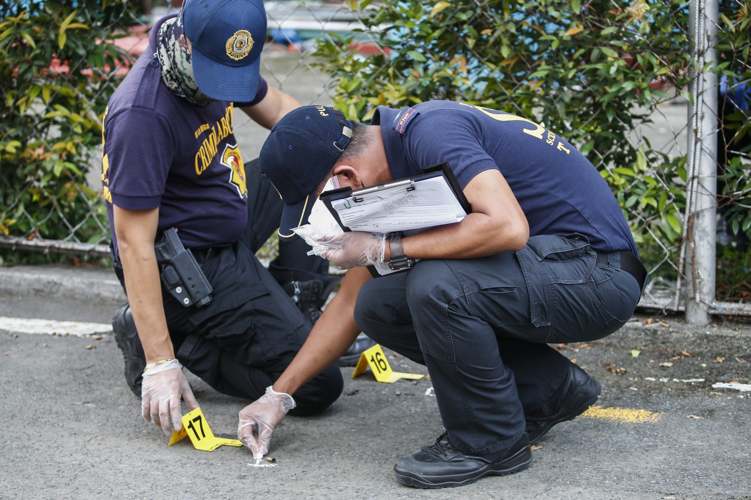 epa10089474 Philippine police investigate at areas related to a shooting incident at a university in Quezon City, Metro Manila, Philippines, 24 July 2022. Three people were killed and one other sustained injuries from a shooting incident as a law school commencement ceremony was scheduled to be held at the Ateneo de Manila University in Quezon City. Police investigators continue to determine motives for the shooting following the arrest of a suspect in the incident.  EPA/ROLEX DELA PENA