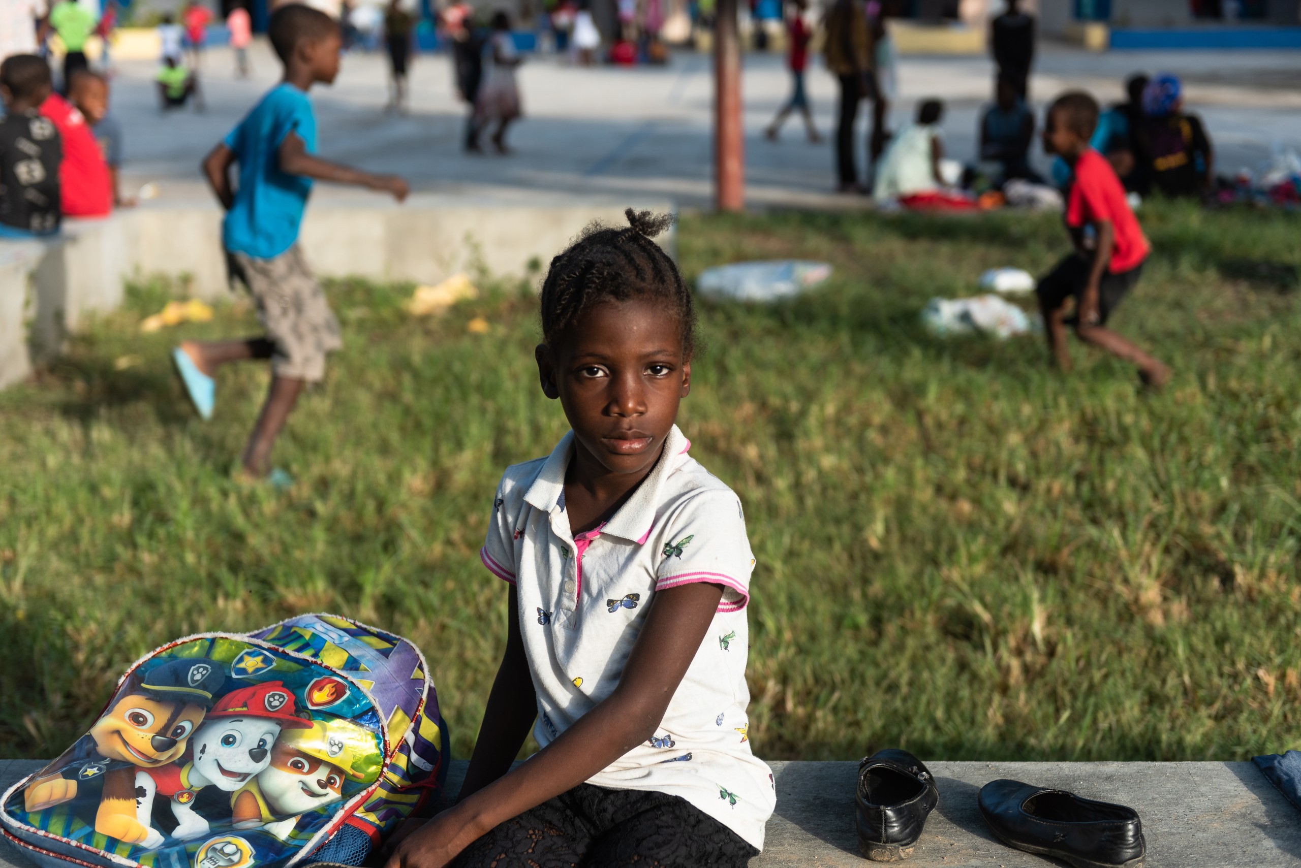 epa10091226 A girl who lived in Cite Soleil and was displaced due to the gang war in her neighborhood is seen in Port-au-Prince, Haiti, 23 July 2022 (issued 25 July 2022). Hundreds of minors have fled from Cite Soleil, a municipality in the metropolitan region of Port-au-Prince, the scene of a bloody war between armed gangs in recent weeks. There the clashes have left more than a hundred dead and thousands of new displaced, according to humanitarian and human rights organizations.  EPA/Johnson Sabin