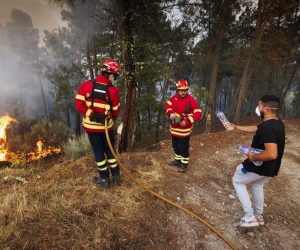 epa10096487 Firemen fights a forest fire in Reboredo village, Vila Pouca de Aguiar, Portugal, 28 July 2022. A total of 466 operational, 144 vehicles and six airplane are fighting the forest fire.  EPA/PEDRO SARMENTO COSTA
