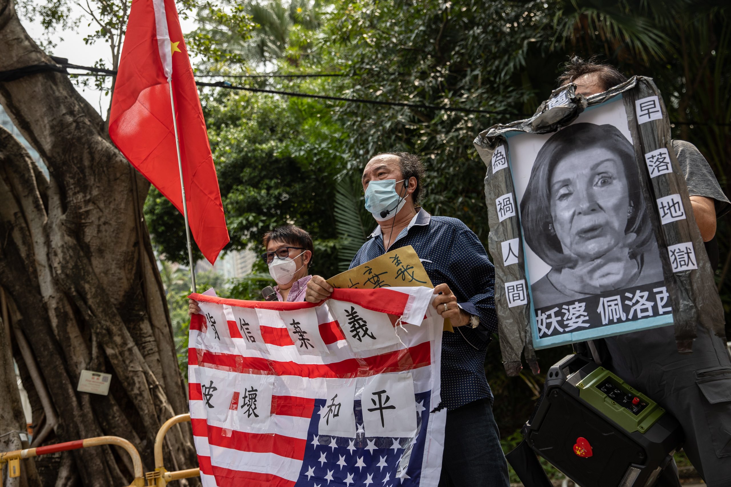 epa10103680 A group of pro-China supporters displays a mock up funeral photo of the US House Speaker Nancy Pelosi and an inverted US flag outside of the US Consulate General in Hong Kong and Macau, in Hong Kong, China, 03 August 2022. The group protested the visit to Taiwan by Nancy Pelosi who is leading a Congressional delegation to the Indo-Pacific region with stops in Singapore, Malaysia, South Korea and Japan.  EPA/JEROME FAVRE