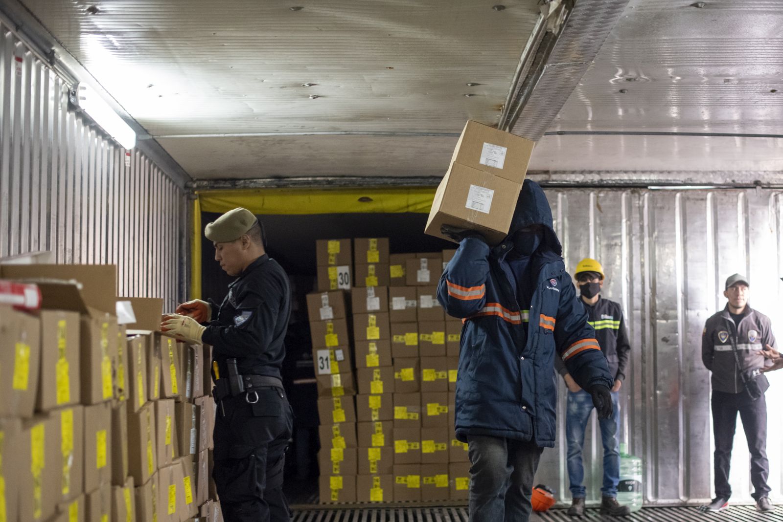 epa10104179 Anti-narcotics police search for drugs in several containers, in the Port of Guayaquil, in Guayaquil, Ecuador, 22 July 2022 (Issued 3 August 2022). Through fake fruits, inside wood, between boxes of shrimp, bananas, cereals, scrap, or even in tea bottles, drug trafficking has made the port of Guayaquil in Ecuador one of the great springboards to 'export' tons of cocaine in multiple forms from South America to mainly Europe and the United States.  EPA/Mauricio Torres