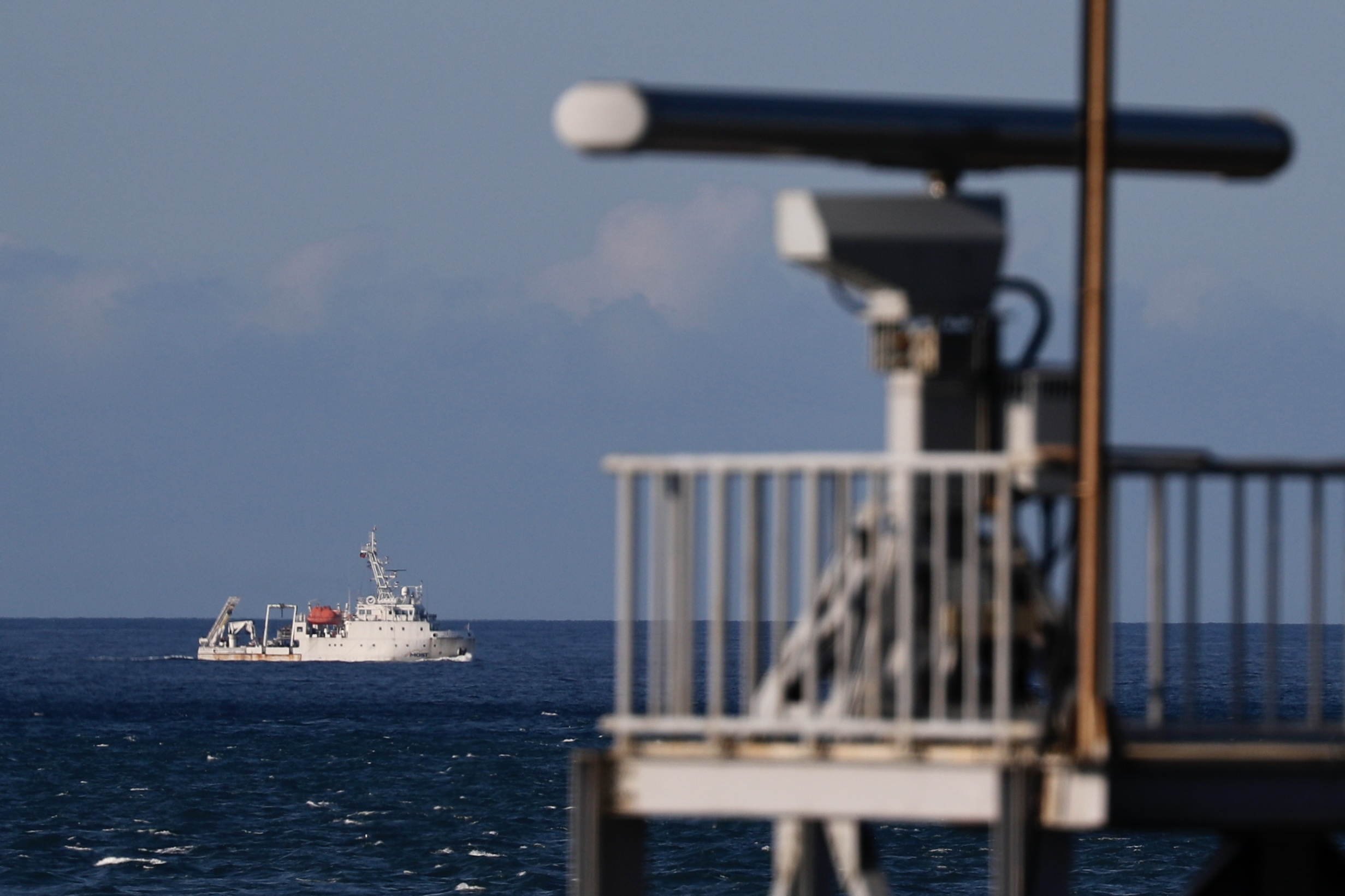 epa10105305 A marine vessel maneuver past a radar tower as it sails away from the location where the Chinese military believed to conduct a live fire drill, is seen from the coast of New Taipei city, Taiwan, 04 August 2022. After the visit of US house Speaker Nancy Pelosi in Taiwan, the Chinese military hold a series of live-fire drills in six maritime areas near Taiwan from 04 - 07 August 2022.  EPA/RITCHIE B. TONGO