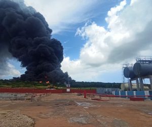 epa10109189 A column of smoke generated by the fire in a fuel depot in Matanzas, Cuba, 06 August 2022. According to a Cuban Presidency report, some 17 firefighters went missing while battling the fire in a petroleum deposit.  EPA/Ernesto Mastrascusa
