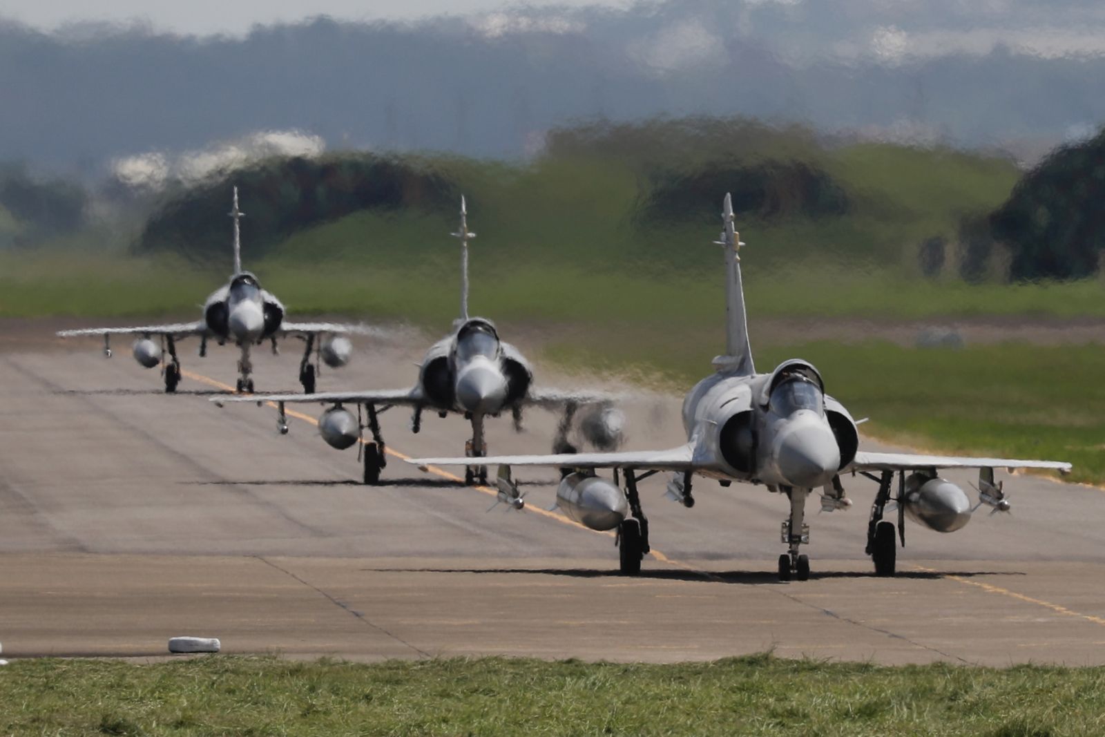 epaselect epa10109557 Three Taiwanese Air Force Mirage 2000-5 fighter jets taxi on the runway before take off at an airbase in Hsinchu, Taiwan, 07 August 2022. Following a visit of US House of Representatives Speaker Pelosi to Taiwan, the Chinese military started to hold a series of live-fire drills in six maritime areas around Taiwan's main islan from 04 to 07 August 2022.  EPA/RITCHIE B. TONGO