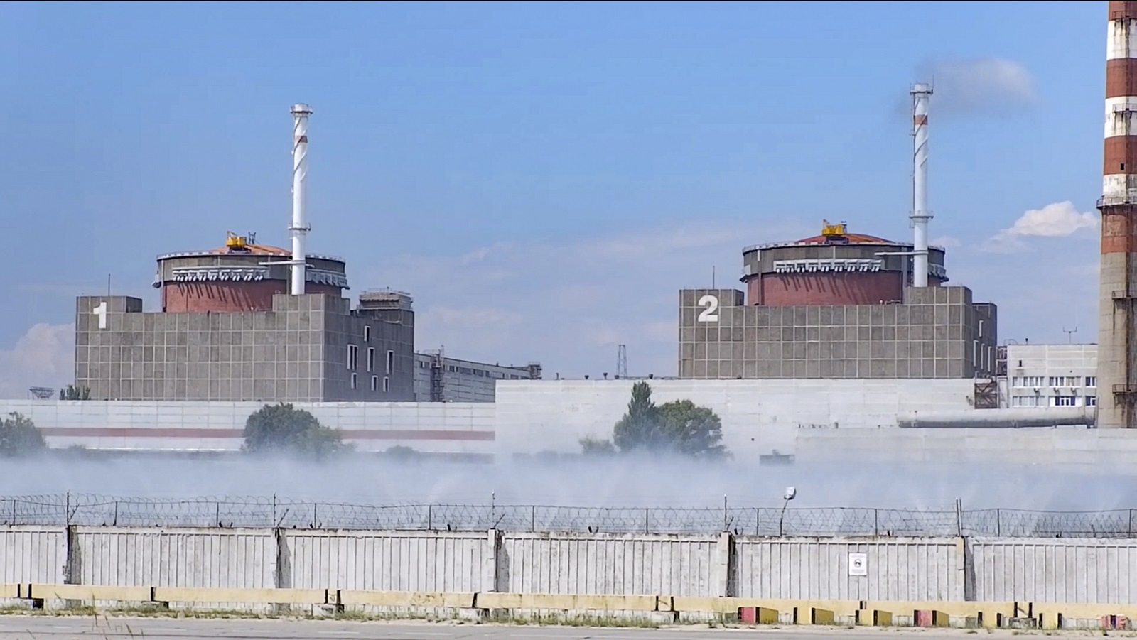 epa10110517 A still image taken a handout video provided  by the Russian Defence Ministry's press service shows a general view of the Zaporizhzhia Nuclear Power Station (ZNPP) in Enerhodar, southeastern Ukraine, 07 August 2022. The administration of Russian-controlled Enerhodar said that Ukrainian forces "launched a strike using a 220-mm Uragan MLRS rocket" towards the ZNPP and that it had "managed to open up and release fragmentation submunitions" while approaching, whereas Ukrainian state-owned plant operator Energatom stated that the Russian forces on 06 August "fired rockets at the site of the Zaporizhzhya nuclear power plant and the city of Energodar" hitting next to the ZNPP's facility where spent nuclear fuel is stored. Zaporizhzhia NPP with six power units is the largest nuclear power plant in Europe and was seized by Russian forces early in March 2022. Russian troops on 24 February entered Ukrainian territory, starting an armed conflict that has provoked destruction and a humanitarian crisis.  EPA/RUSSIAN EMERGENCIES MINISTRY HANDOUT  HANDOUT EDITORIAL USE ONLY/NO SALES