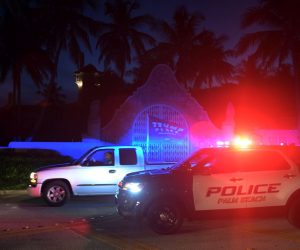 epa10112020 Authorities stand outside Mar-a-Lago, the residence of former president Donald Trump, amid reports of the FBI executing a search warrant as a part of a document investigation, in Palm Beach, Florida, USA, 08 August 2022.  EPA/JIM RASSOL