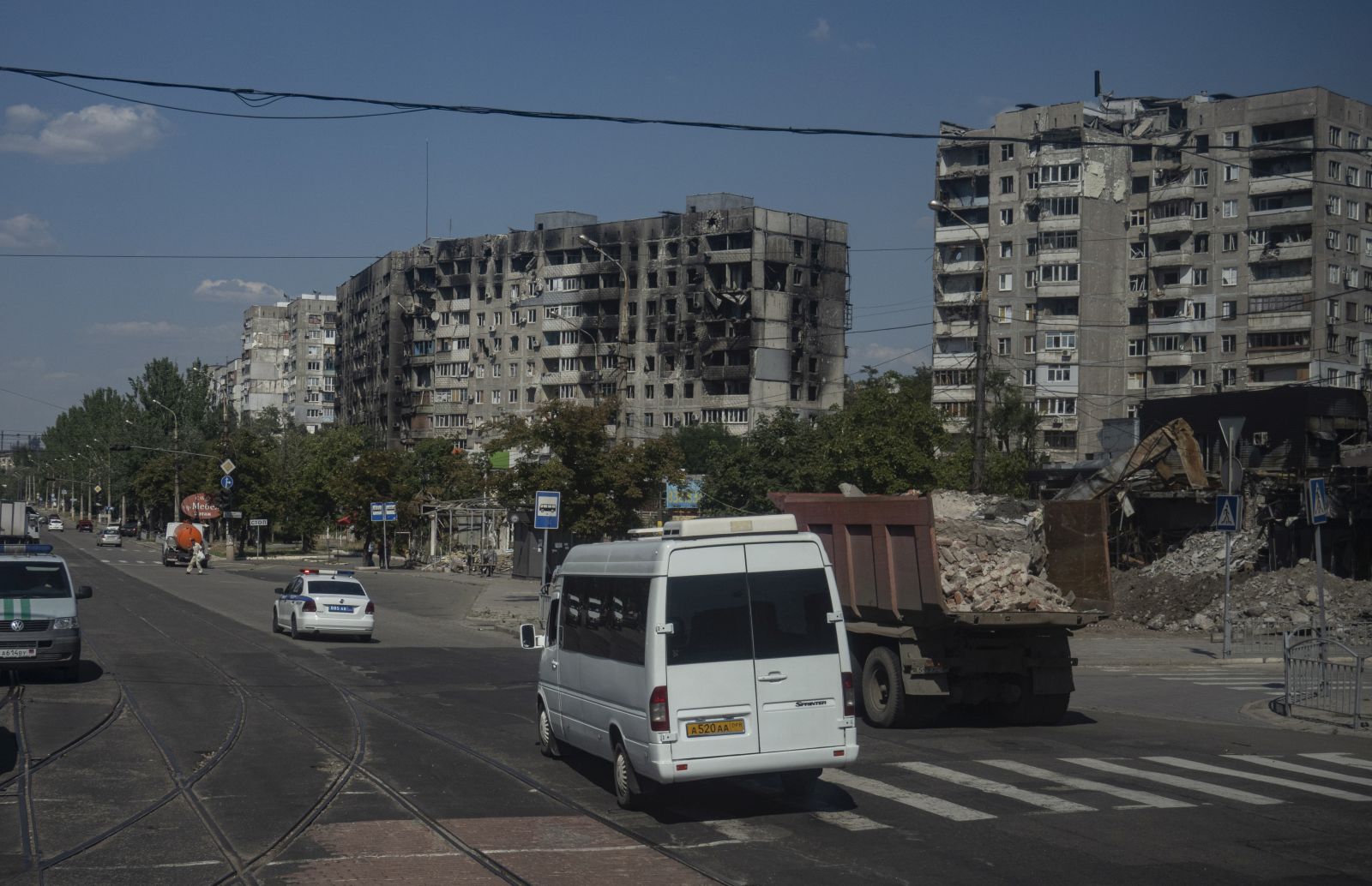 epa10114359 A picture taken during a visit to Mariupol organised by the Russian military shows traffic in a damaged residential district in Mariupol, Donetsk region, Ukraine, 10 August 2022. Twelve five-storey houses with 1,011 apartments are being built. This number of apartments will accommodate more than 2,500 people. About 1,000 people work at the construction site, more than 150 pieces of equipment are involved, according to Oleg Pechenkin, project manager of the military construction complex of the Russian Defense Ministry, as construction and restoration of residential districts, hospitals and engineering networks began in Mariupol. The first building will be completed by September 2022.  EPA/SERGEI ILNITSKY