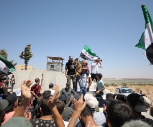 epa10117197 Syrian people protest near a Turkish military post against Turkish calls for reconciliation between rebels and the Syrian government, in Al-Mastumah village, seven kilometers south of Idlib, Syria, 12 August 2022. Protests erupted in cities in northern Syria that are held by Syrian opposition groups a day after Turkish Foreign Minister Mevlut Cavusoglu's statements on possible reconciliation between the Syrian opposition and government.  EPA/YAHYA NEMAH
