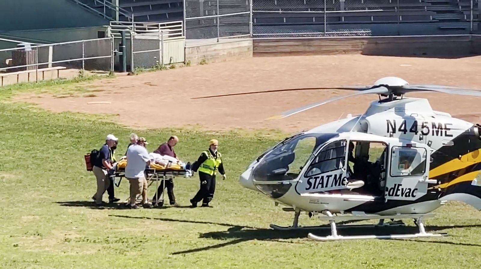 epa10117604 Frame grab from a video released via Twitter user @HoratioGates3 and used with permission, showing Salman Rushdie being loaded into a MedEvac helicopter after he and an interviewer were attacked while on stage at an event in Chautauqua, New York State, USA, 12 August 2022. The suspect was taken into custody, New York State police said. Rushdie, who was reportedly stabbed in the neck, was transported to a hospital.  EPA/@HoratioGates3 EDITORIAL USE ONLY, NO SALES HANDOUT EDITORIAL USE ONLY/NO SALES