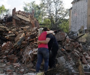epa10127151 Women hug near the debris of a building that was damaged after a rocket hit the Saltivka area in Kharkiv, Ukraine, 18 August 2022. At least seven people were killed and 17 injured during the attack according to the Ukrainian State Emergency Service. A total of at least 11 people were  killed and 37 injured in the entire Kharkiv region during the overnight attack, the head of Kharkiv oblast military administration said. Kharkiv and surrounding areas have been the target of heavy shelling since February 2022, when Russian troops entered Ukraine starting a conflict that has provoked destruction and a humanitarian crisis.  EPA/VASILIY ZHLOBSKY