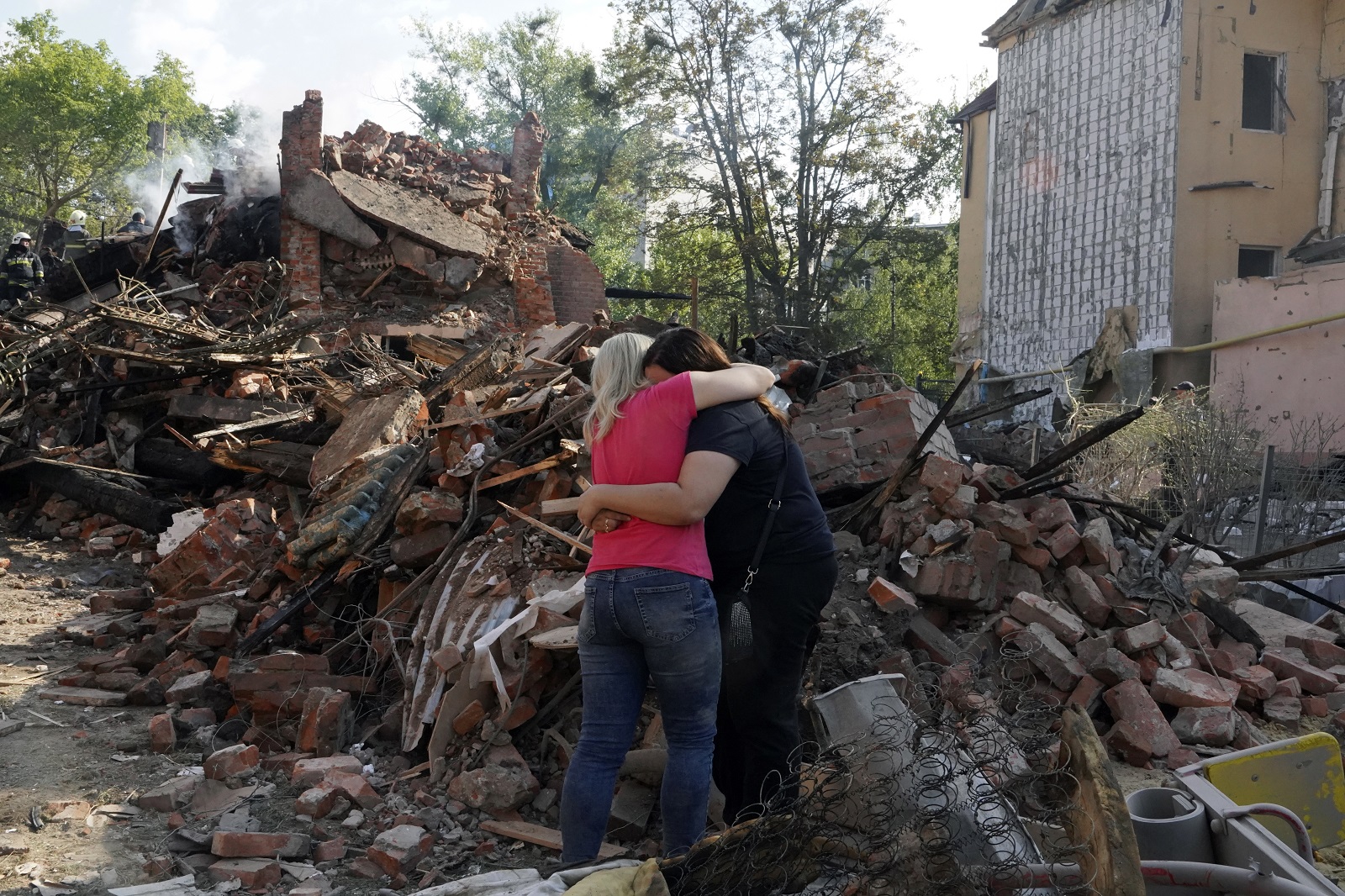 epa10127151 Women hug near the debris of a building that was damaged after a rocket hit the Saltivka area in Kharkiv, Ukraine, 18 August 2022. At least seven people were killed and 17 injured during the attack according to the Ukrainian State Emergency Service. A total of at least 11 people were  killed and 37 injured in the entire Kharkiv region during the overnight attack, the head of Kharkiv oblast military administration said. Kharkiv and surrounding areas have been the target of heavy shelling since February 2022, when Russian troops entered Ukraine starting a conflict that has provoked destruction and a humanitarian crisis.  EPA/VASILIY ZHLOBSKY