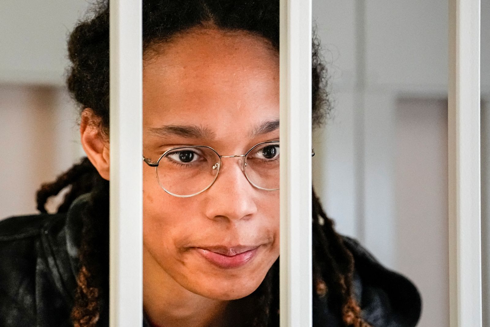 WNBA star and two-time Olympic gold medalist Brittney Griner speaks to her lawyers standing in a cage at a court room prior to a hearing, in Khimki just outside Moscow, Russia, July 26, 2022. Alexander Zemlianichenko/Pool via REUTERS