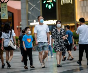 epa10146963 People wearing face masks walk around Jiefangbei pedestrian street in Chongqing, China, 30 August 2022. Local authorities implemented tighter COVID-19 restrictions after 11 cases were detected in Chongqing, by imposing mass testing and establishing temporary control areas.  EPA/WU HAO