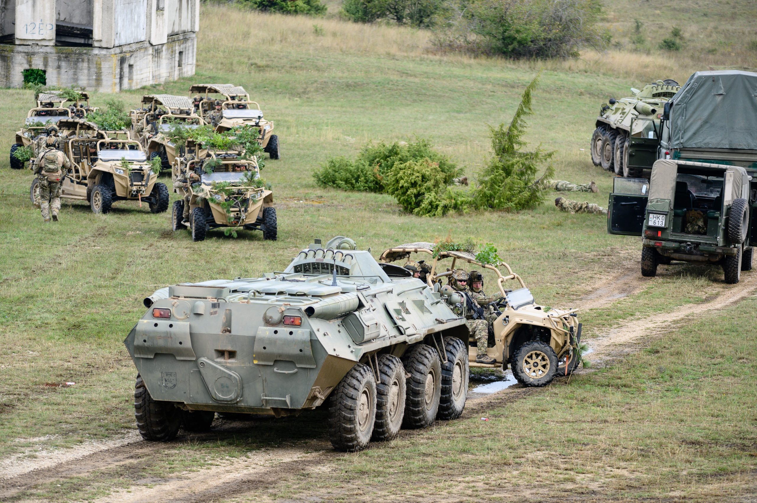epa10152528 Soldiers ride a BTR-80 amphibious armoured personnel carrier (F) and several Polaris MRZR ultra-light combat vehicles during a special exercise of the Hungarian military to increase reactive and combat capabilities at the army's Bakony Combat Training Centre near Ujdorogd, western Hungary, 01 September 2022. In early summer a higher degree of military alertness was ordered in Hungary to respond to increased security risks in connection with the protracted war in neighbouring Ukraine and the growing pressure of illegal migration at the country's southern borders.  EPA/Tamas Vasvari HUNGARY OUT