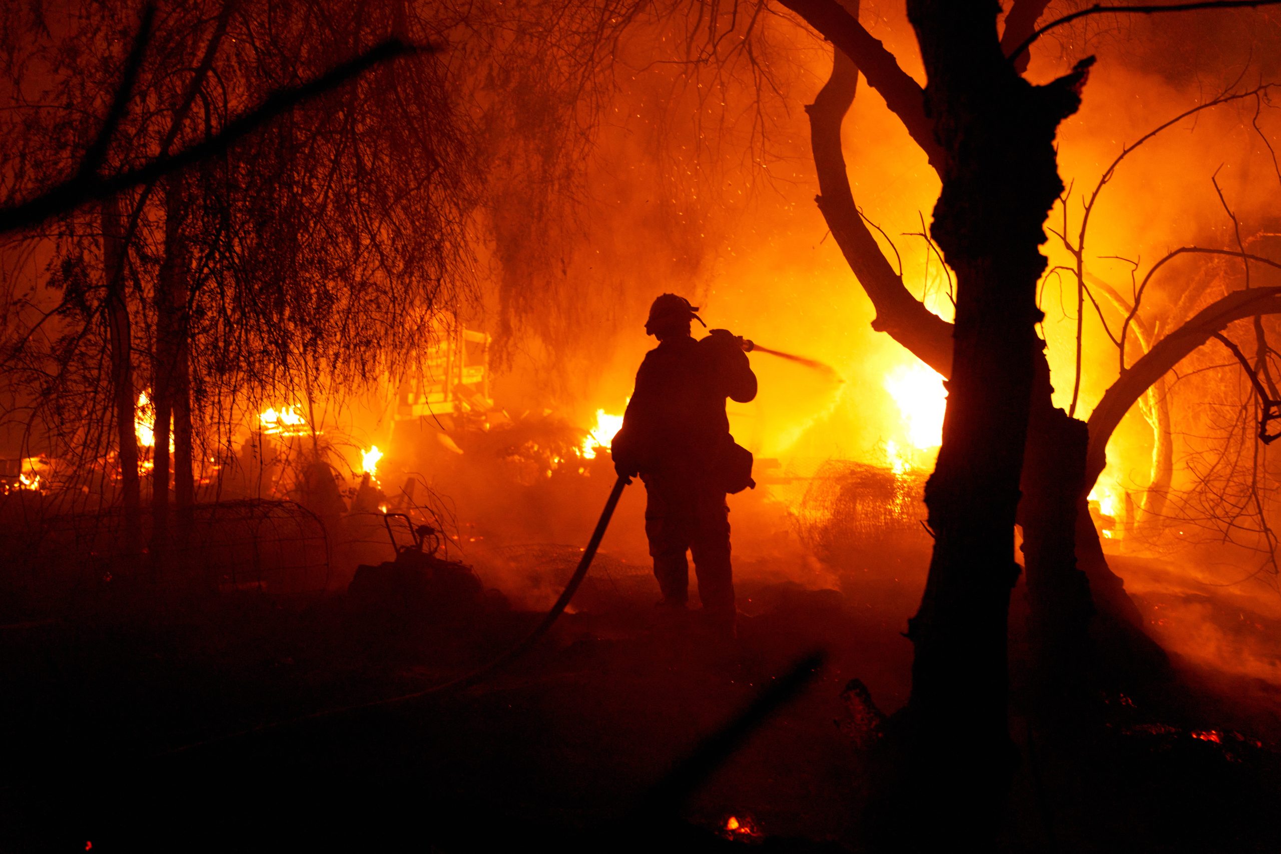 epa10163280 Fire fighters try to put out the Fairview Fire as it burns a home on Gibbel Road in Hemet, California, USA, 05 September 2022 (issued 06 September 2022). The fire expanded to over 2,000 acres, destroying multiple structures and claiming two lives.  EPA/Allison Dinner