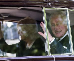 epa10179455 Britain's King Charles III and Camilla, the Queen Consort, gesture as they are driven on the way to Westminster, in London, Britain, 12 September 2022. King Charles III will address Parliament for the first time as monarch on 12 September. King Charles III was announced as the new sovereign during a meeting of the Accession Council on 10 September following the death of Britain's Queen Elizabeth II at her Scottish estate on 08 September.  EPA/OLIVIER HOSLET