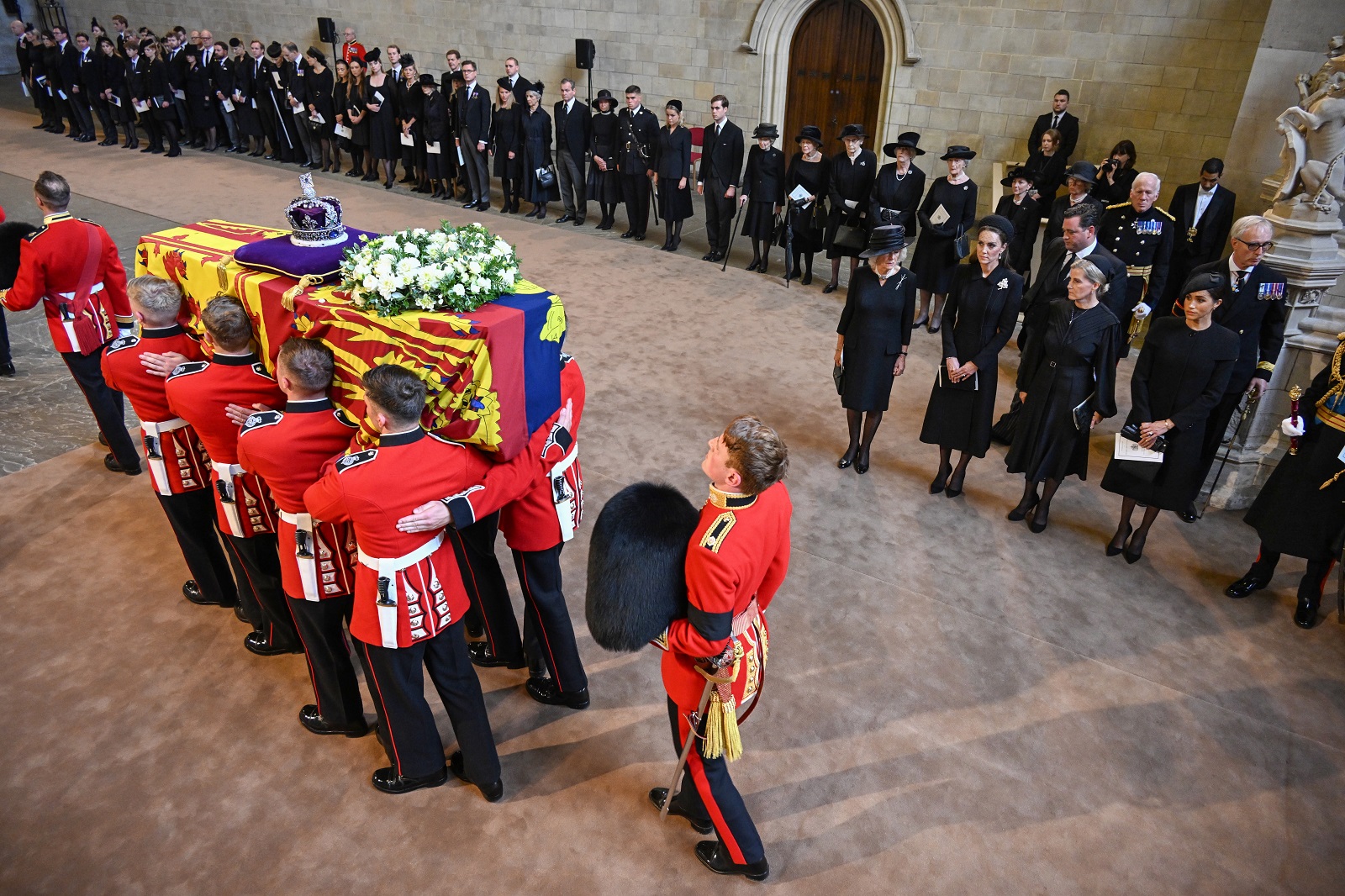 epa10184697 A handout photograph released by the UK Parliament shows pallbearers carrying in the coffin of Britain's Queen Elizabeth II past (L-R) Britain's Camilla, Queen Consort; Catherine, Princess of Wales; Sophie, Countess of Wessex; and Meghan, Duchess of Sussex into Westminster Hall for the service for the commencement of the Queen's Lying-in-State at the Palace of Westminster in London, Britain, 14 September 2022. The queen's lying in state will last for four days, ending on the morning of the state funeral on the 19 September.  EPA/UK PARLIAMENT/JESSICA TAYLOR HANDOUT -- MANDATORY CREDIT: UK PARLIAMENT/JESSICA TAYLOR -- HANDOUT EDITORIAL USE ONLY/NO SALES