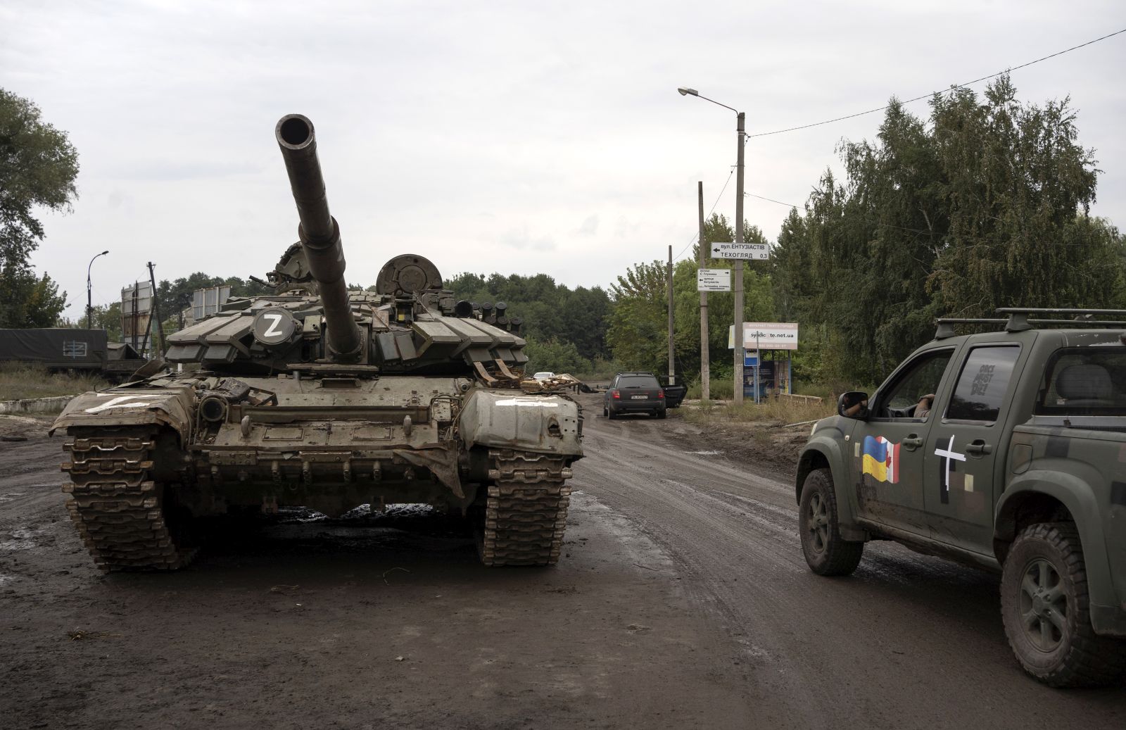 epa10186105 A Ukrainian military vehicle (R) passes by a destroyed Russian tank (L) in the reclaimed city of Izyum, Ukraine, 15 September 2022. The Ukrainian army pushed Russian troops from occupied territory in the northeast of the country in a counterattack. Kharkiv and surrounding areas have been the target of heavy shelling since February 2022, when Russian troops entered Ukraine starting a conflict that has provoked destruction and a humanitarian crisis.  EPA/ANASTASIA VLASOVA