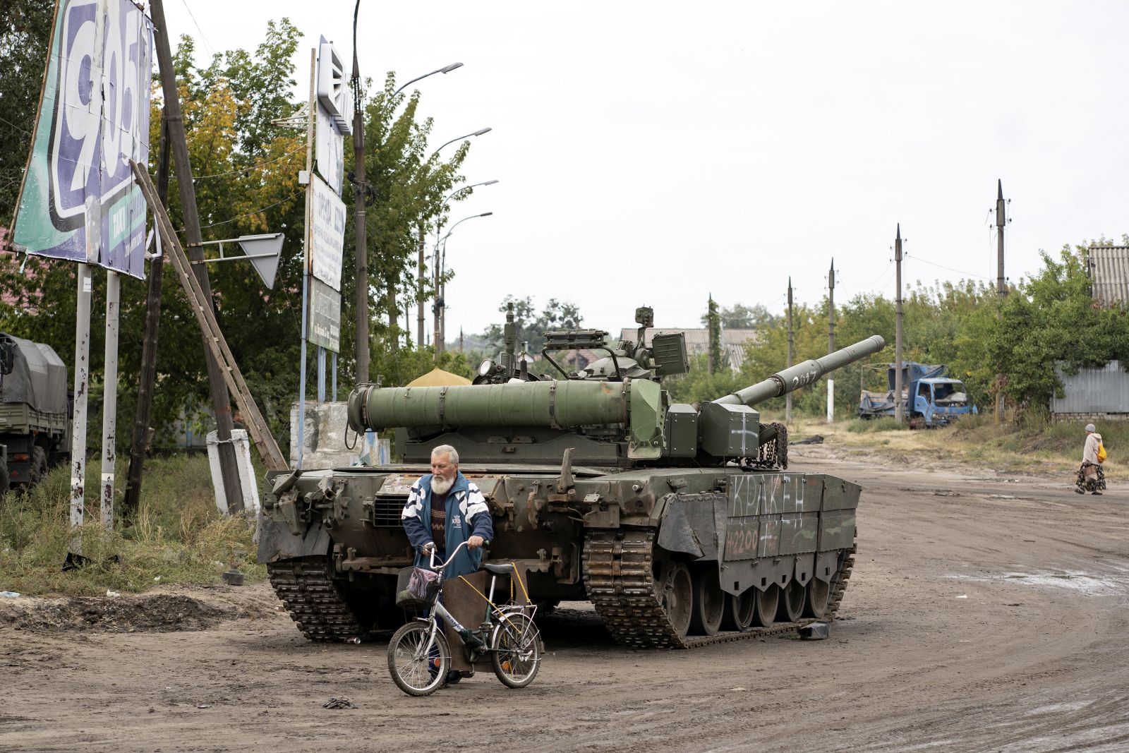 epa10186097 Local resident walks by a Ukrainian tank in the reclaimed city of Izyum, Ukraine, 15 September 2022. The Ukrainian army pushed Russian troops from occupied territory in the northeast of the country in a counterattack. Kharkiv and surrounding areas have been the target of heavy shelling since February 2022, when Russian troops entered Ukraine starting a conflict that has provoked destruction and a humanitarian crisis.  EPA/ANASTASIA VLASOVA