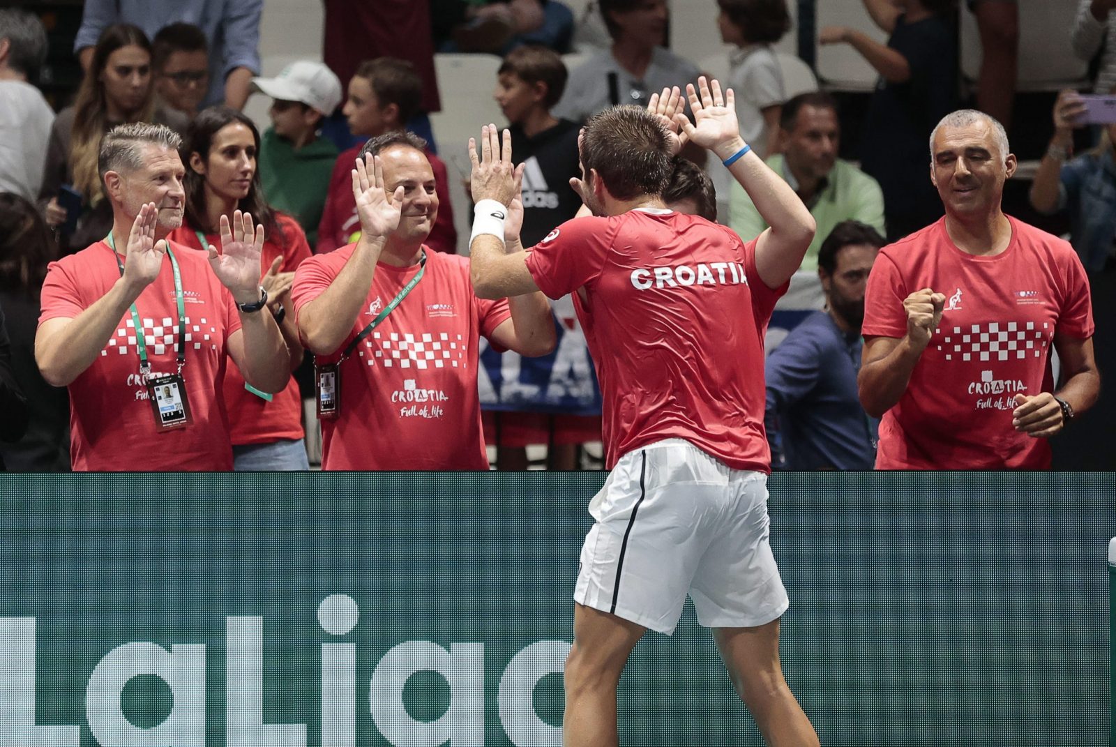 epa10186453 Borna Coric (front) of Croatia celebrates with team members after defeating Mikael Ymer of Sweden during the Davis Cup Finals group A tie between Croatia and Sweden in Casalecchio, near Bologna, Italy, 15 September 2022.  EPA/ELISABETTA BARACCHI