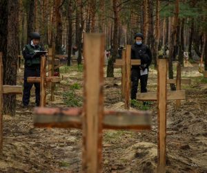 epa10188215 Police officers stand near graves in Izyum, Kharkiv region, northeastern Ukraine, 16 September 2022. A mass burial site was found after Ukrainian troops recaptured the town of Izyum. According to the head of the investigative department of the police of the Kharkiv region, the burial site, one of the largest in a recaptured city so far, counts more than 440 separate graves. The Ukrainian army pushed Russian troops from occupied territory in the northeast of the country in a counterattack. Kharkiv and surrounding areas have been the target of heavy shelling since February 2022, when Russian troops entered Ukraine starting a conflict that has provoked destruction and a humanitarian crisis.  EPA/OLEG PETRASYUK