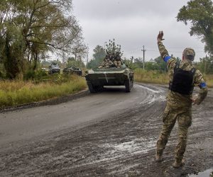 epa10188441 A Ukrainian serviceman waves at his comrades riding an armoured personnel carrier (APC) near the urban settlement of Kazachya Lopan, north of Kharkiv, northeastern Ukraine, 16 September 2022, amid Russia's invasion. The Ukrainian army pushed Russian troops from occupied territory in the northeast of the country in a counterattack. Kharkiv and surrounding areas have been the target of heavy shelling since February 2022, when Russian troops entered Ukraine starting a conflict that has provoked destruction and a humanitarian crisis.  EPA/SERGEY KOZLOV