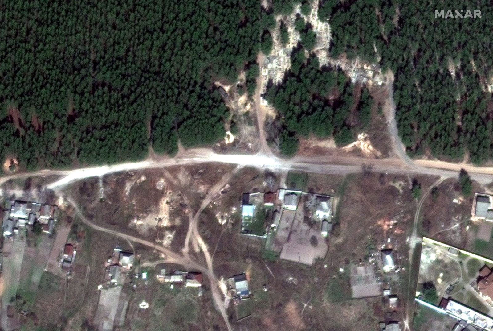 epa10189375 A handout satellite image made available by Maxar Technologies shows artillerty pieces deployed near the entrance to the cemetary in Izyum, Ukraine, 08 April 2022 (issued 17 September 2022). According to statements from Ukraine President Volodymyr Zelensky, bodies found in a mass burial site near Izyum, an area recently taken back from Russian forces, show signs of torture. Governor of Kharkiv Oblast Oleg Synegubov stated that civilians were among the dead, and some of the more than 440 bodies found buried at the site had their hands bound behind their backs.  EPA/MAXAR TECHNOLOGIES HANDOUT -- MANDATORY CREDIT: SATELLITE IMAGE 2022 MAXAR TECHNOLOGIES -- THE WATERMARK MAY NOT BE REMOVED/CROPPED -- HANDOUT EDITORIAL USE ONLY/NO SALES