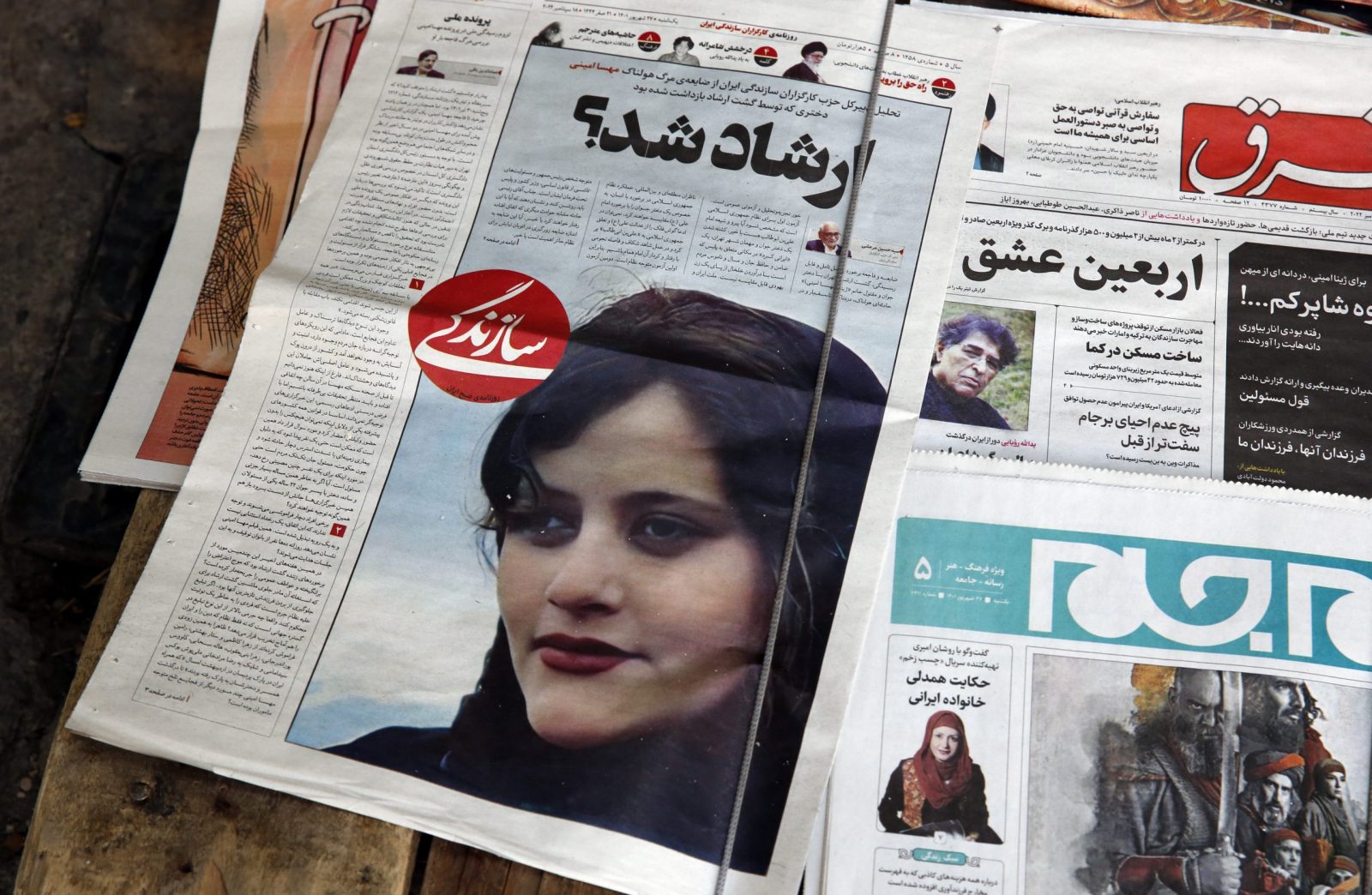 epa10191412 Iranian daily newspapers reporting Mahsa Amini’s death, in Tehran, Iran, 18 September 2022. Mahsa Amini, a 22 year old girl, was detained on 13 September by the police unit responsible for enforcing Iran's strict dress code for women. Amini was declared dead on 16 September, after she spent 3 days in a coma. Protests broke out in Saqez, hometown of Amini during her funeral on 17 September.  EPA/ABEDIN TAHERKENAREH