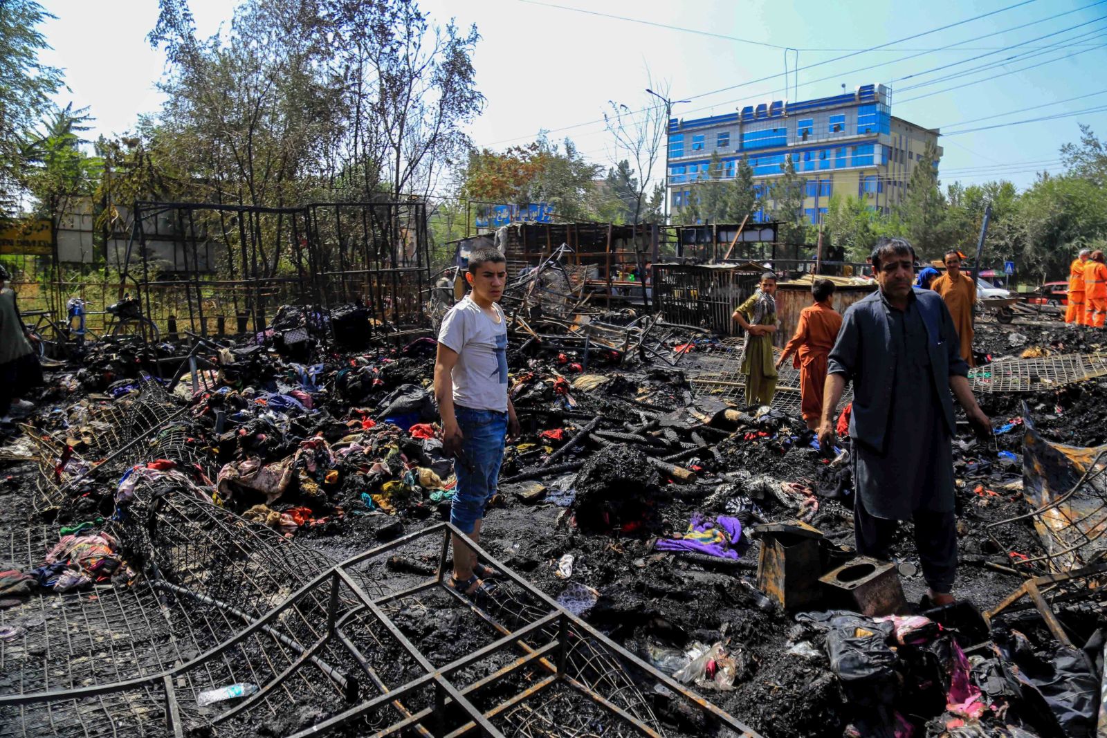 epa10191759 People survey the burnt-out, auction market that sells used items after a fire broke out, in Kabul, Afghanistan, 18 September 2022.  Residents said that the fire caused huge financial losses. The cause of the fire is unknown.  EPA/STRINGER