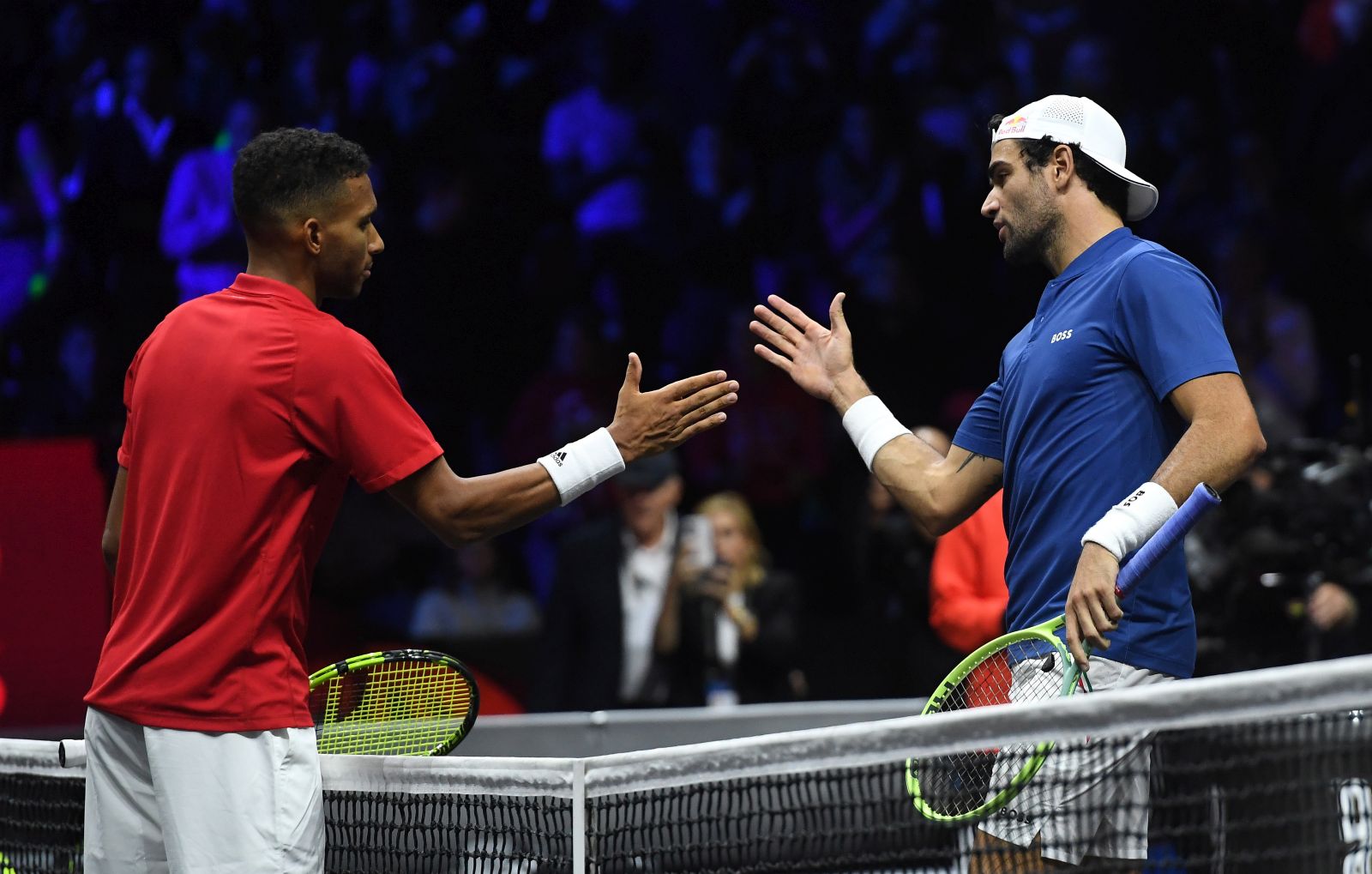 epa10203699 Matteo Berrettini of Team Europe (R) following his win over Felix Auger-Aliassime (L) of Team World during a Laver Cup tennis match at the O2 Arena in London, Britain, 24 September 2022.  EPA/ANDY RAIN