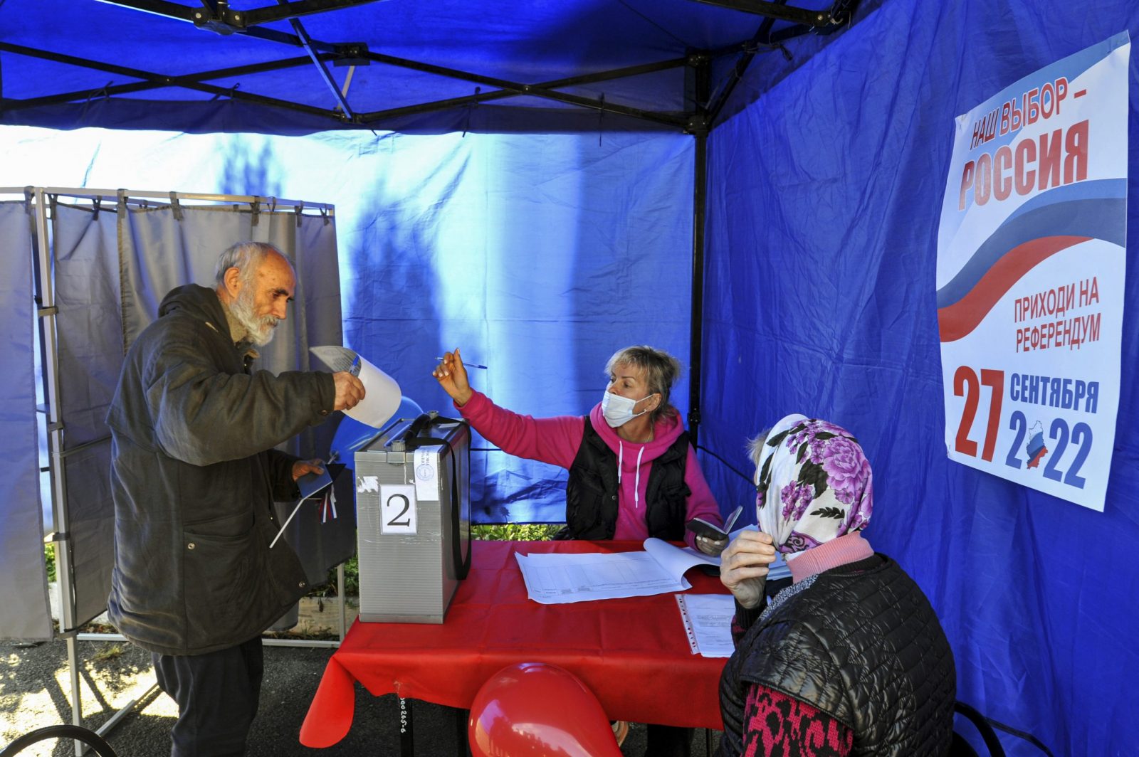 epa10204182 A refugee from Ukraine (L) casts his ballots at a polling station in a temporary accommodation facility for refugees during voting in a referendum on the joining of Russian-controlled regions of Ukraine to Russia, in Novocherkassk, Rostov region, Russia, 24 September 2022. From 23 to 27 September, residents of the self-proclaimed Luhansk and Donetsk People's Republics as well as the Russian-controlled areas of the Kherson and Zaporizhzhia regions of Ukraine vote in a referendum to join the Russian Federation. On 24 February 2022 Russian troops entered the Ukrainian territory in what the Russian president declared a 'Special Military Operation', starting an armed conflict that has provoked destruction and a humanitarian crisis. Since then, more than 3.3 million refugees from eastern and southern Ukraine have entered Russia through the Rostov region, according to data published on 22 September by the press service of its regional government.  EPA/STRINGER