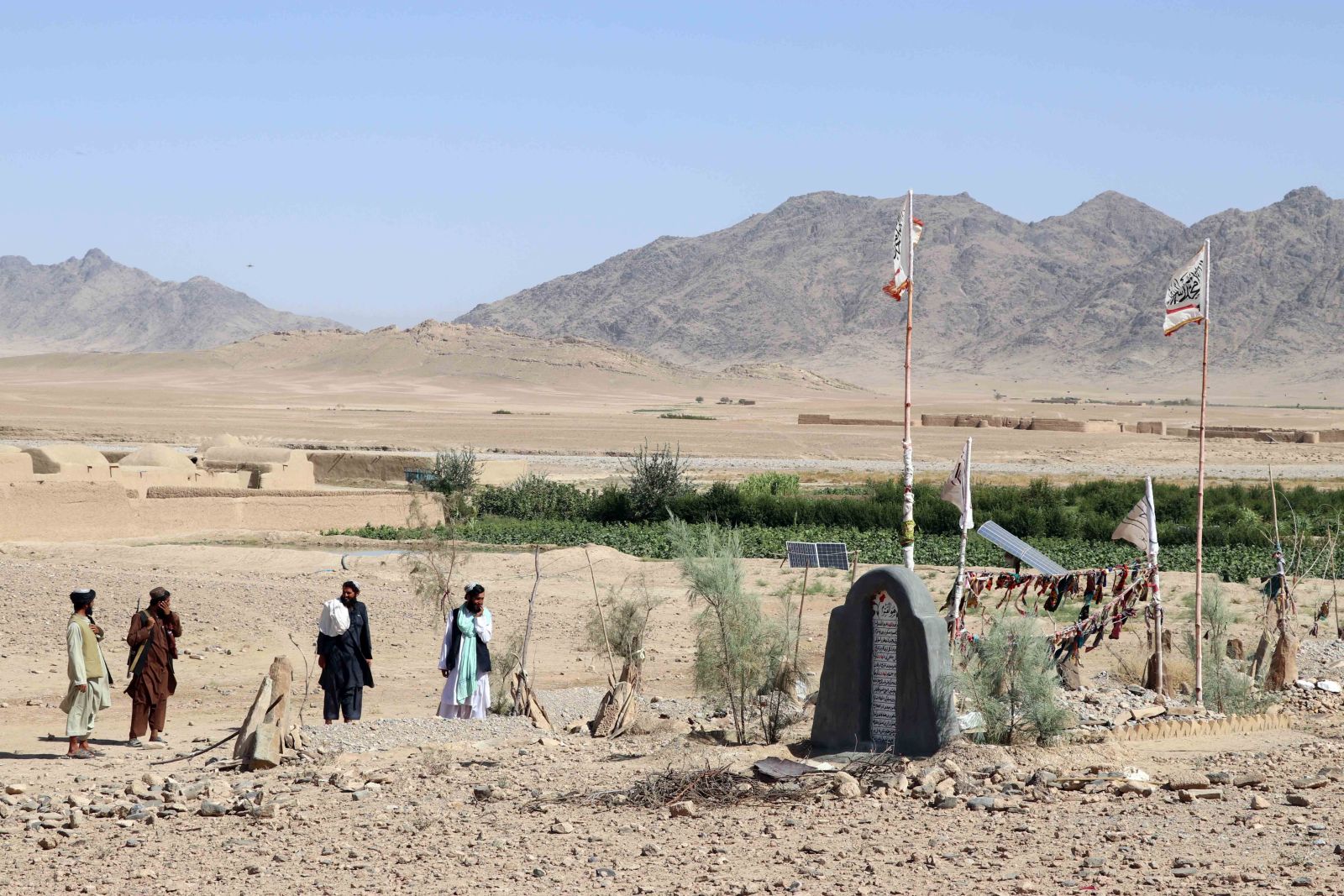epa10208237 Taliban and local residents visit the site of a mass-grave and the re-burial of the mortal remains, that was found by locals in Spin Boldak, Kandahar, Afghanistan, 26 September 2022. Taliban officials said on 26 September, that the remains of 12 people were found in a mass grave in Spin Boldak, a town on the border with Pakistan, a few days ago. Spin Boldak was the site of fierce fighting between the Afghan government and Taliban fighters before the Taliban took power in 2021. The UN rapporteur for Afghanistan’s human rights Richard Bennett said that it is 'important these remains are not disturbed and damaged further pending forensic examination, while being sensitive to needs of families.' The deputy spokesman of the Islamic Emirate, Bilal Karimi, said that the grave site and human remains are from eight years ago and that investigations are underway in this regard.  EPA/STRINGER