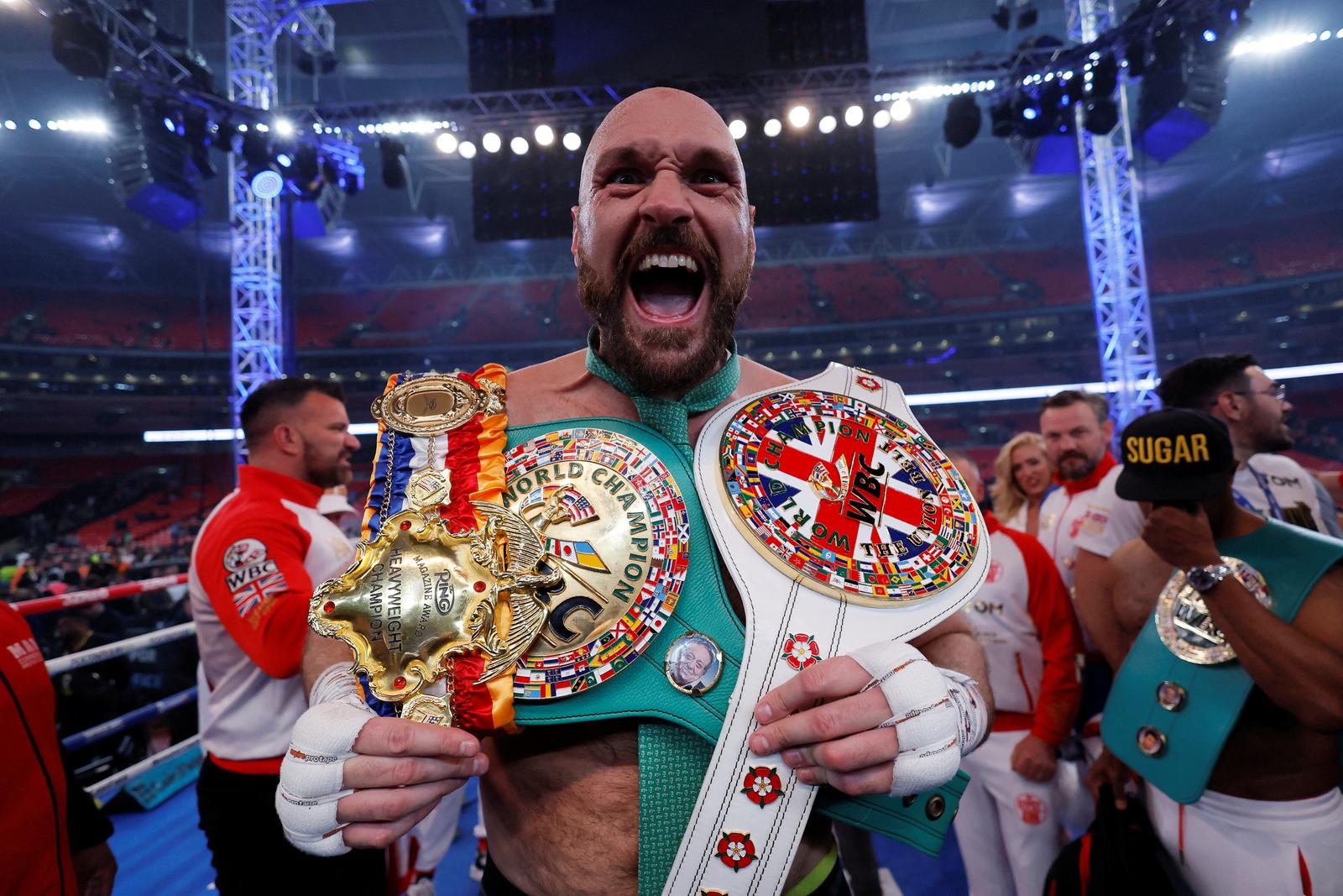 FILE PHOTO: Boxing - Tyson Fury v Dillian Whyte - WBC World Heavyweight Title - Wembley Stadium, London, Britain - April 23, 2022  Tyson Fury celebrates with the belts after winning his fight against Dillian Whyte Action Images via Reuters/Andrew Couldridge/File Photo Photo: Andrew Couldridge/REUTERS