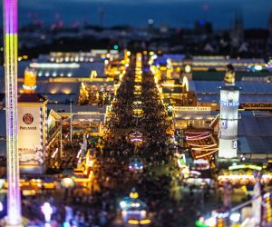 epa10190450 A picture taken with a tilt-shift lens shows a general view on beer tents and crowds during the 187th edition of the traditional Oktoberfest beer and amusement festival in the German Bavaria state's capital Munich, Germany, 17 September 2022. The Oktoberfest 2022 runs from 17 September to 03 October 2022 and several millions of visitors are expected from all over the world. The event resumes after being canceled for two years in a row due to the coronavirus disease (COVID-19) pandemic.  EPA/CHRISTIAN BRUNA